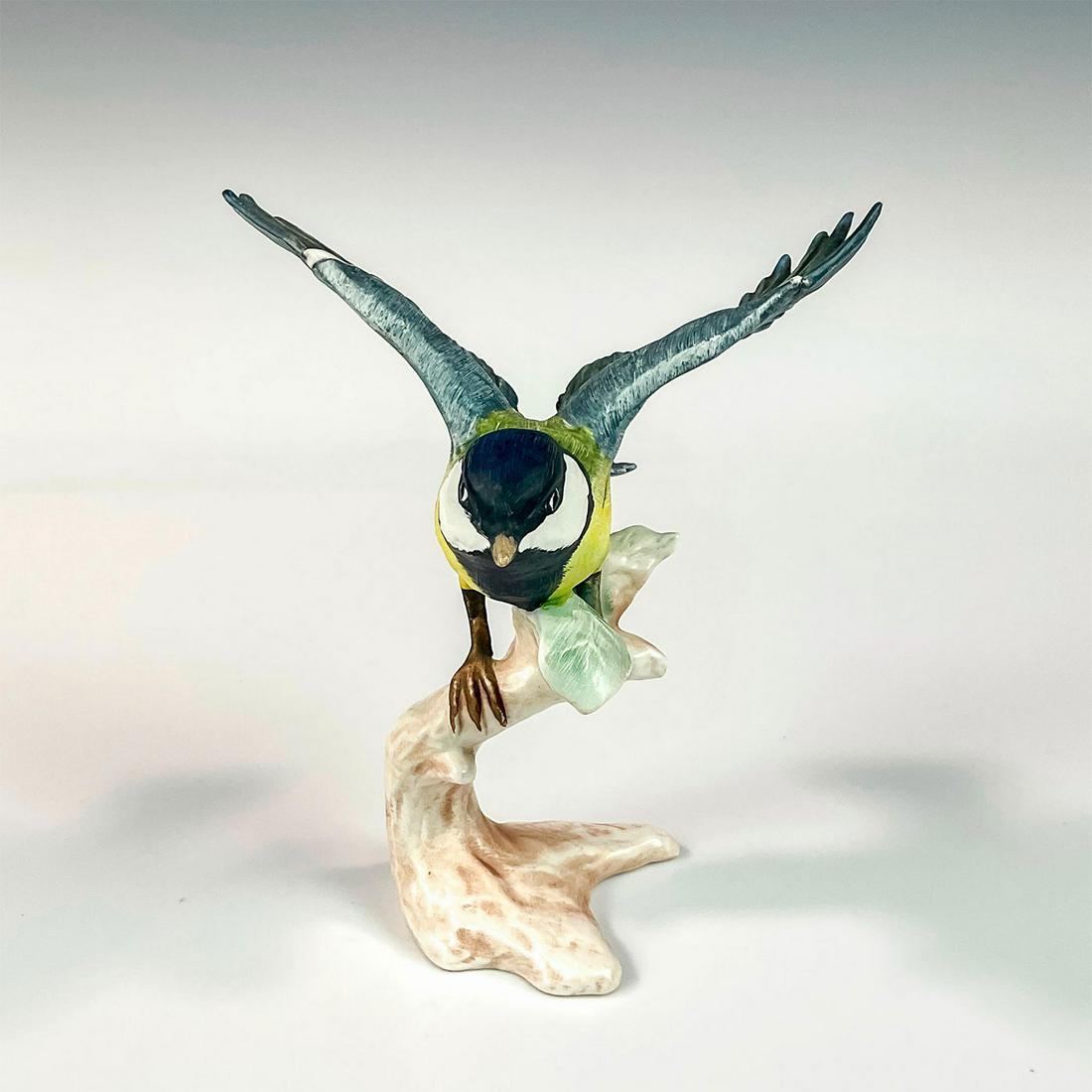 Goebel Porcelain Figurine, Great Titmouse: Bird perched on branch has yellow body with gray wings and tail. Goebel W. Germany backstamp. Issued: 1966 Dimensions: 5"L x 4.25"W x 6"H Manufacturer: Goebel Country of Origin: W. Germany