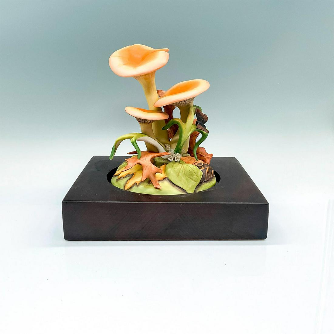 2pc Cybis Porcelain Sculpture, Mushroom Jack-O-Lantern: A beautiful naturalistic orange toadstool figure, surrounded by fallen Autumn leaves, and a butterfly resting on a green leaf. Cybis marking on the side and Cybis impressed mark on the base. This item