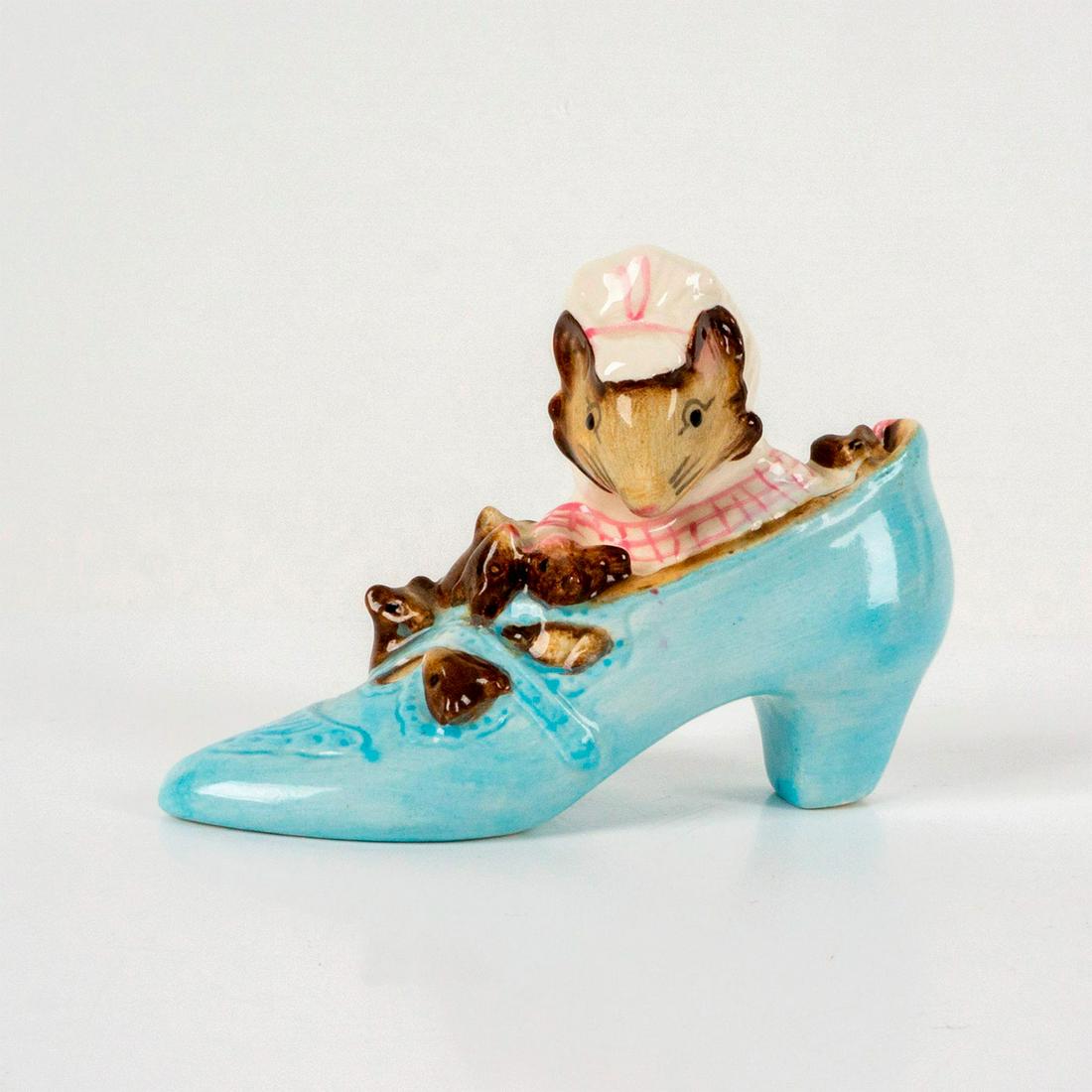 Beswick Beatrix Potter's Figurine, Old Woman Who Lived in Shoe: Depict a mouse wearing a pink and white dress and bonnet living in a sky-blue shoe with her children. Beswick backstamp. Dimensions: 4"L x 1.25"W x 2.75"H Manufacturer: Beatrix Potter Country of Origi