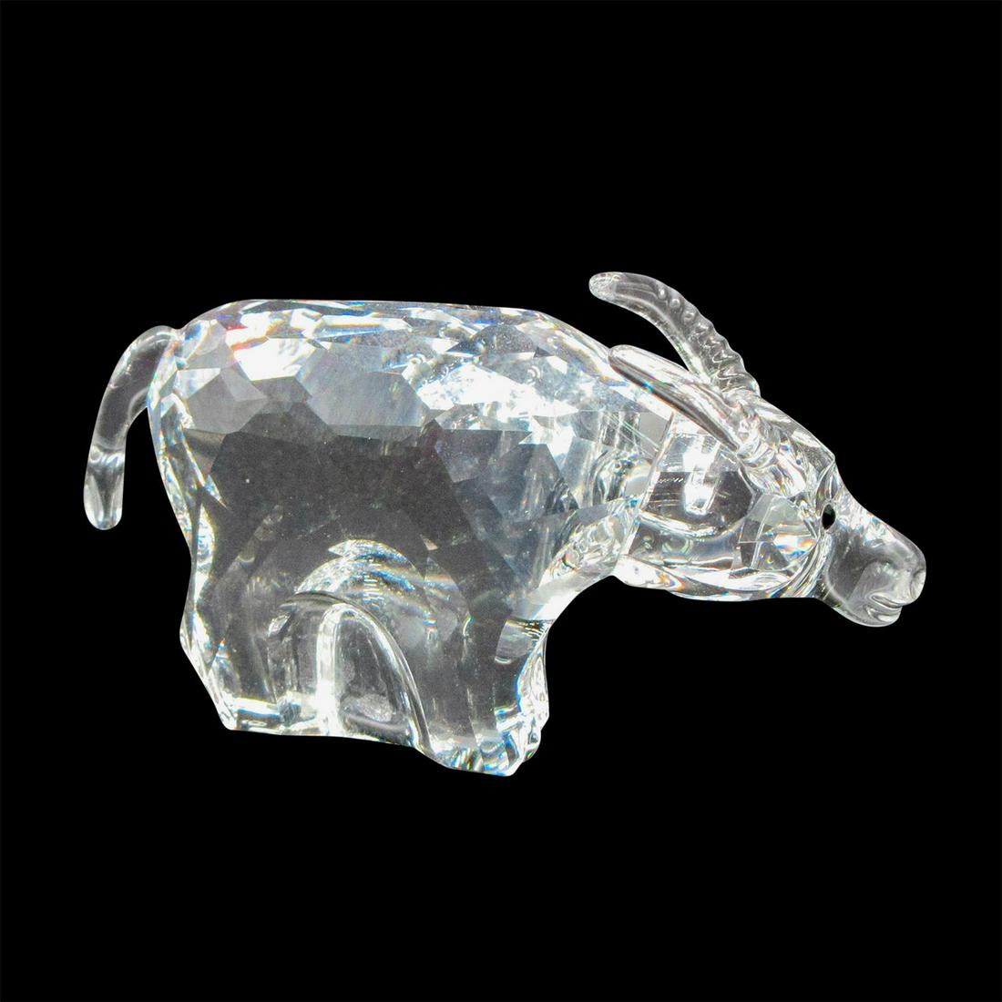 Swarovski Crystal Figurine, Zodiac Ox: Part of Chinese Zodiac signs collection. Clear body with notched detail on horns. Figure has black eyes. Swarovski backstamp. 7693 000 002. Artist: Anton Hirzinger Dimensions: 2.5"L x 0.75"W x 1.5"H M
