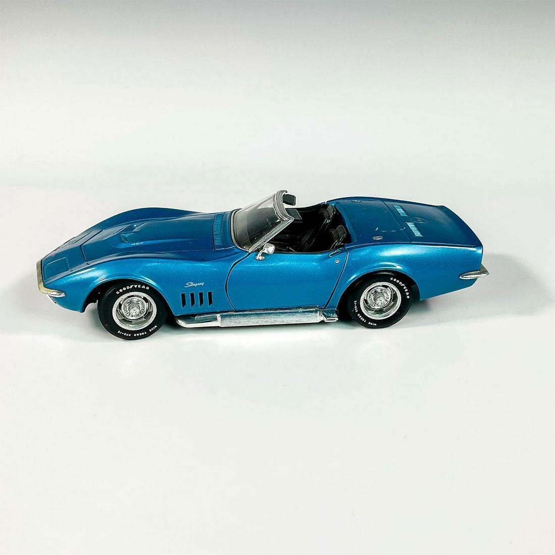 Revell 1969 Corvette Model Car: Replica die cast model Corvette in a blue exterior and black interior. With moveable parts. Issued: 1992 Dimensions: 10.25" x 4"W x 2.5"H Manufacturer: Revell
