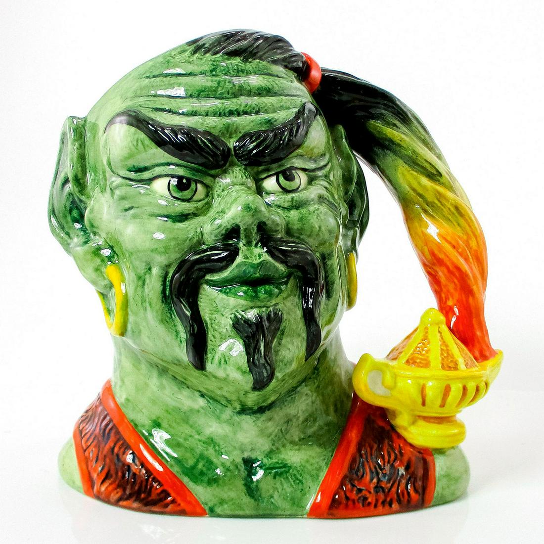 Genie D6892 - Large - Royal Doulton Character Jug: Grey, black, red and yellow coloration. Popularized through legend, the genie is said to reside in a magic lantern and to become the servant of whoever frees him. Artist: Stanley J. Taylor Issued: 199