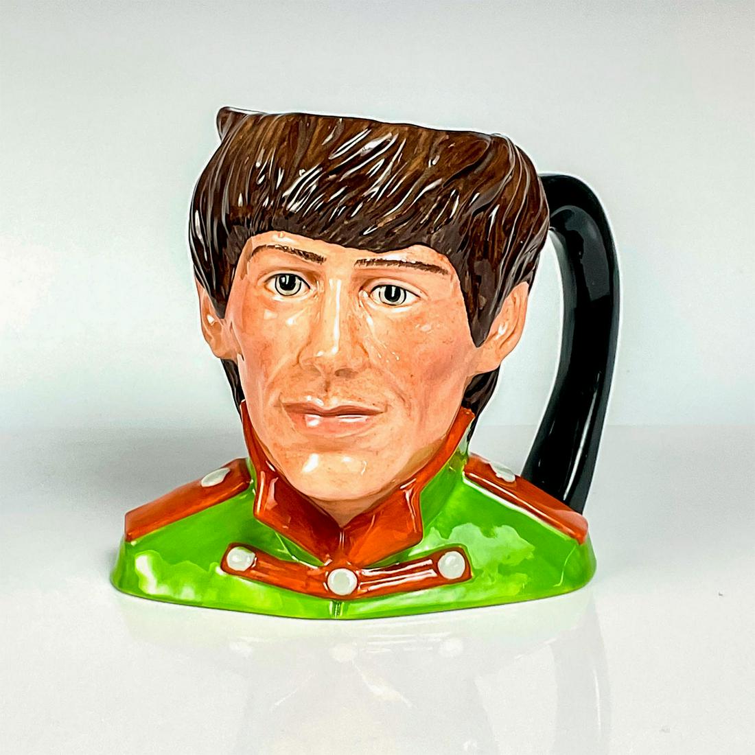 George Harrison D6727 - Odd Size - Royal Doulton Character Jug: Green tunic; orange collar and epaulettes. George Harrison (1943 - 2001) played guitar and wrote songs for the Beatles. Upon the breakup of the group, Harrison pursued a successful solo career until h