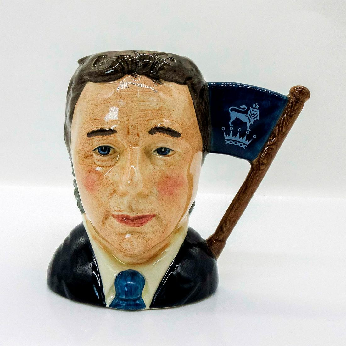 Sir Henry / Michael Doulton D6921 - Small - Royal Doulton Character Jug: Henry- Grey hair; yellow cravat; Michael- Brown hair; dark blue suit; white shirt; light blue tie. Signed by Michael Doulton. This two-faced jug was a special edition jug issued to mark Michael Doulto