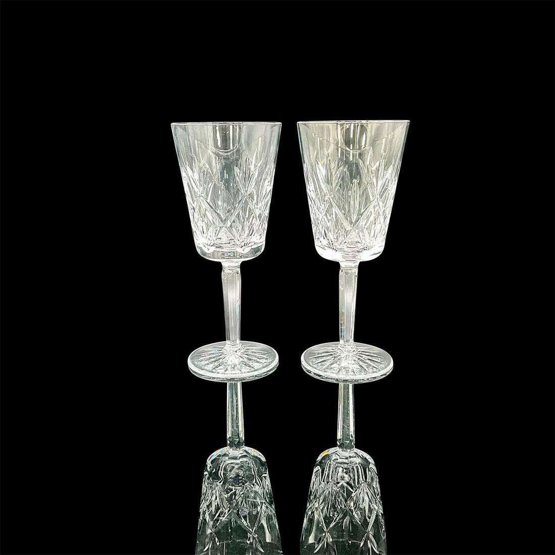 Pair of Tiffany Crystal Claret Wine Glasses: A set of 2 stem drinkware with a cut diamond and fan design. Tiffany and Co. etched on the bases. Dimensions: 3"W x 7.25"H Manufacturer: Tiffany and Co. Country of Origin: United States