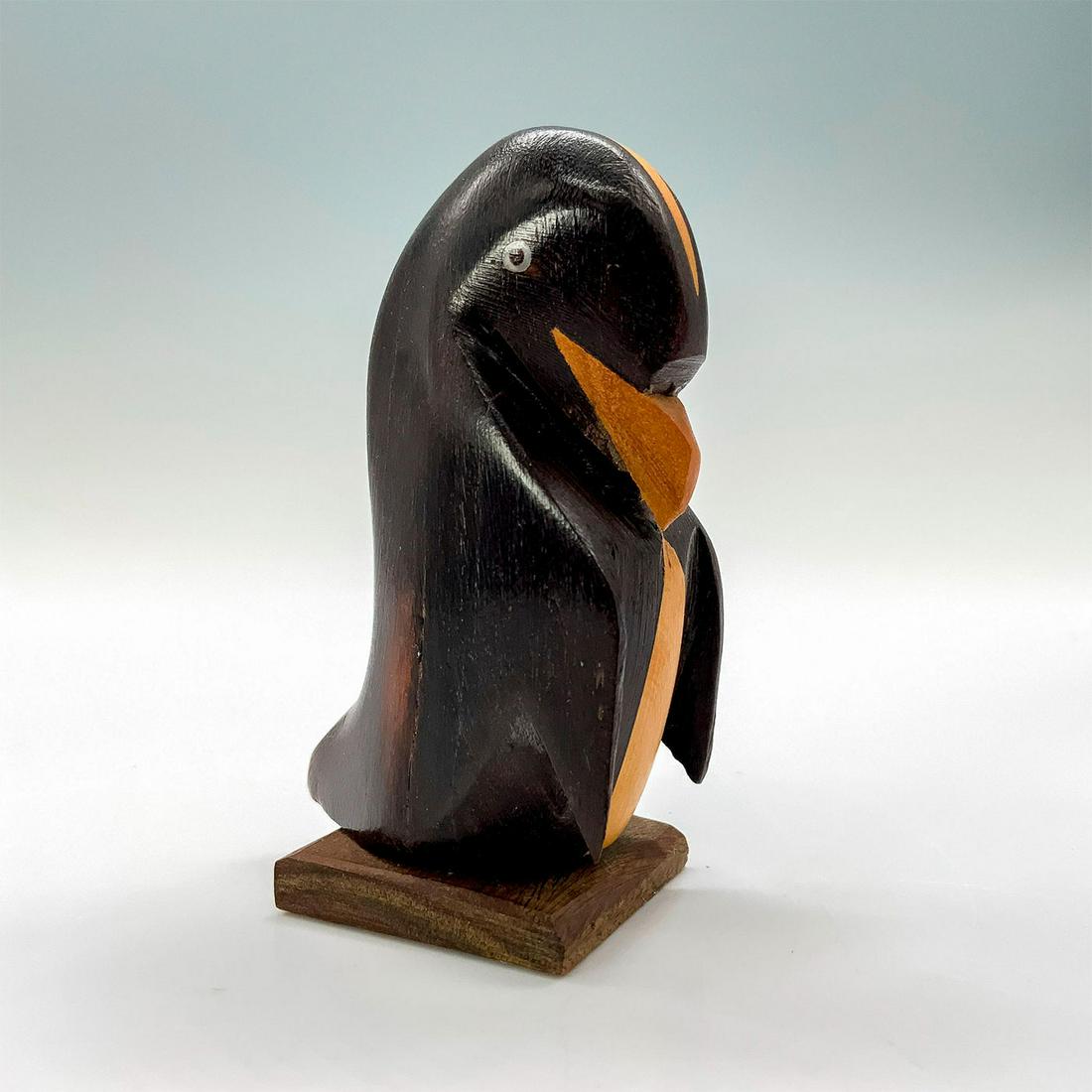 Wooden Penguin Figurine: A figurine of a penguin made of wood painted black with the natural wood color left over for the accents. Dimensions: 1.25"L x 1.5"W x 3.25"H