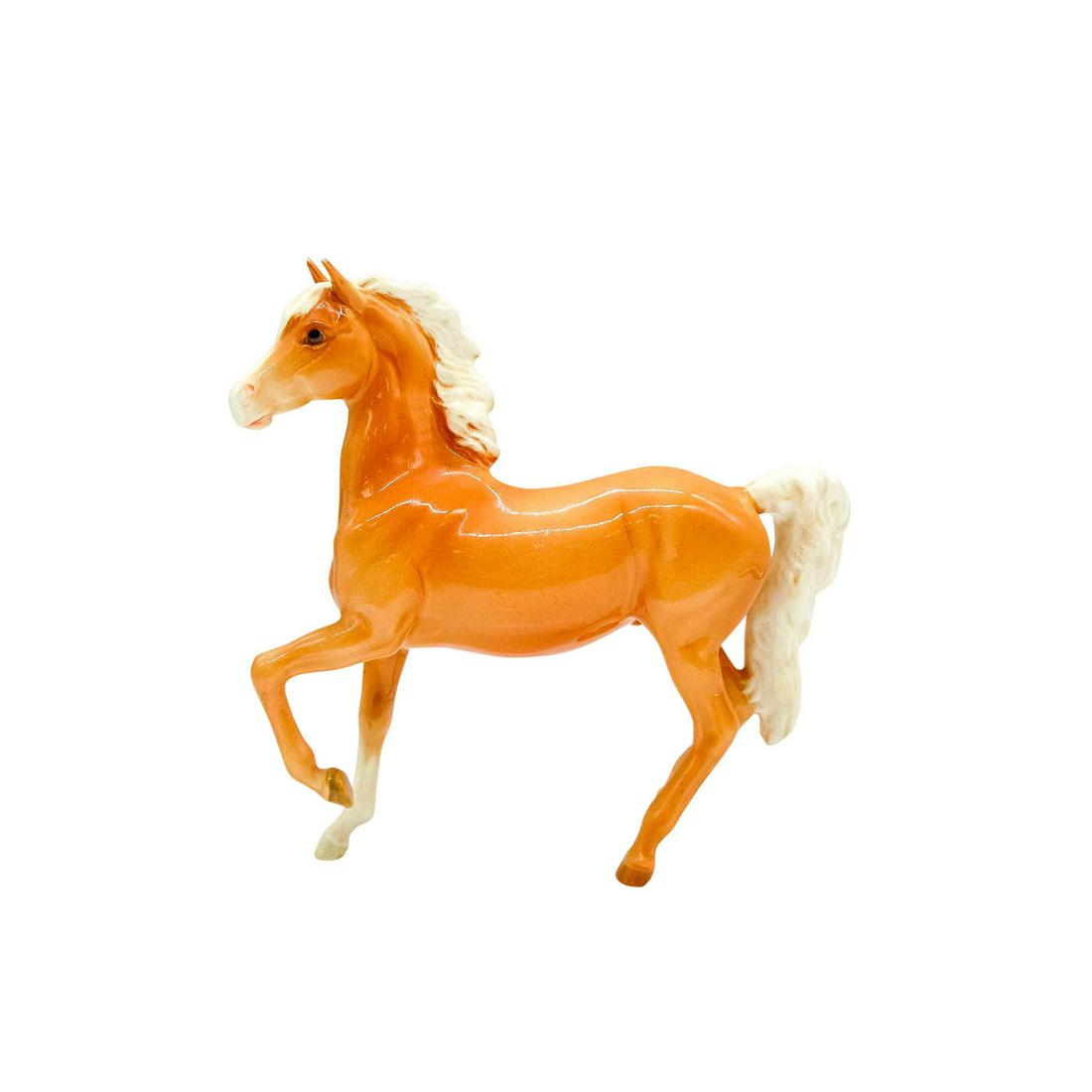 Beswick Porcelain Figurine, Prancing Horse: Gloss finish on Palomino with white mane and thicker tail. Beswick backstamp. 1261. Artist: Arthur Gredington Issued: c. 1952 Dimensions: 6.5"L x 2"W x 6.75"H Edition Number: 1st version Manufacturer: