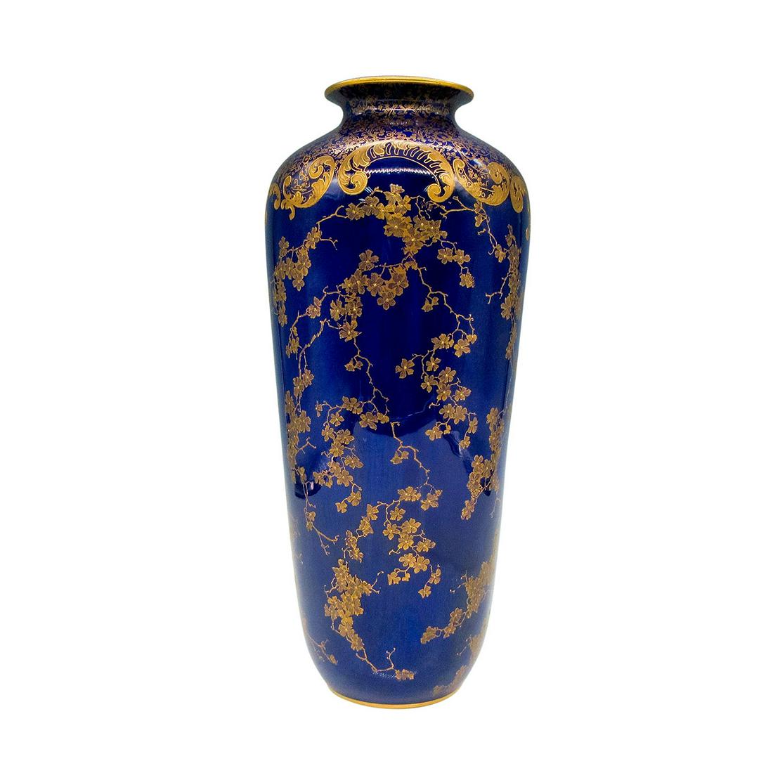 Royal Doulton Porcelain Cobalt Blue Vase RA2119A: Raised gilded floral and vine design. Neck and base have gilded edges. Royal Doulton backstamp. Artist: Robert Allen Issued: c.1900 Dimensions: 4"L x 4"W x 10.25"H Manufacturer: Royal Doulton Country