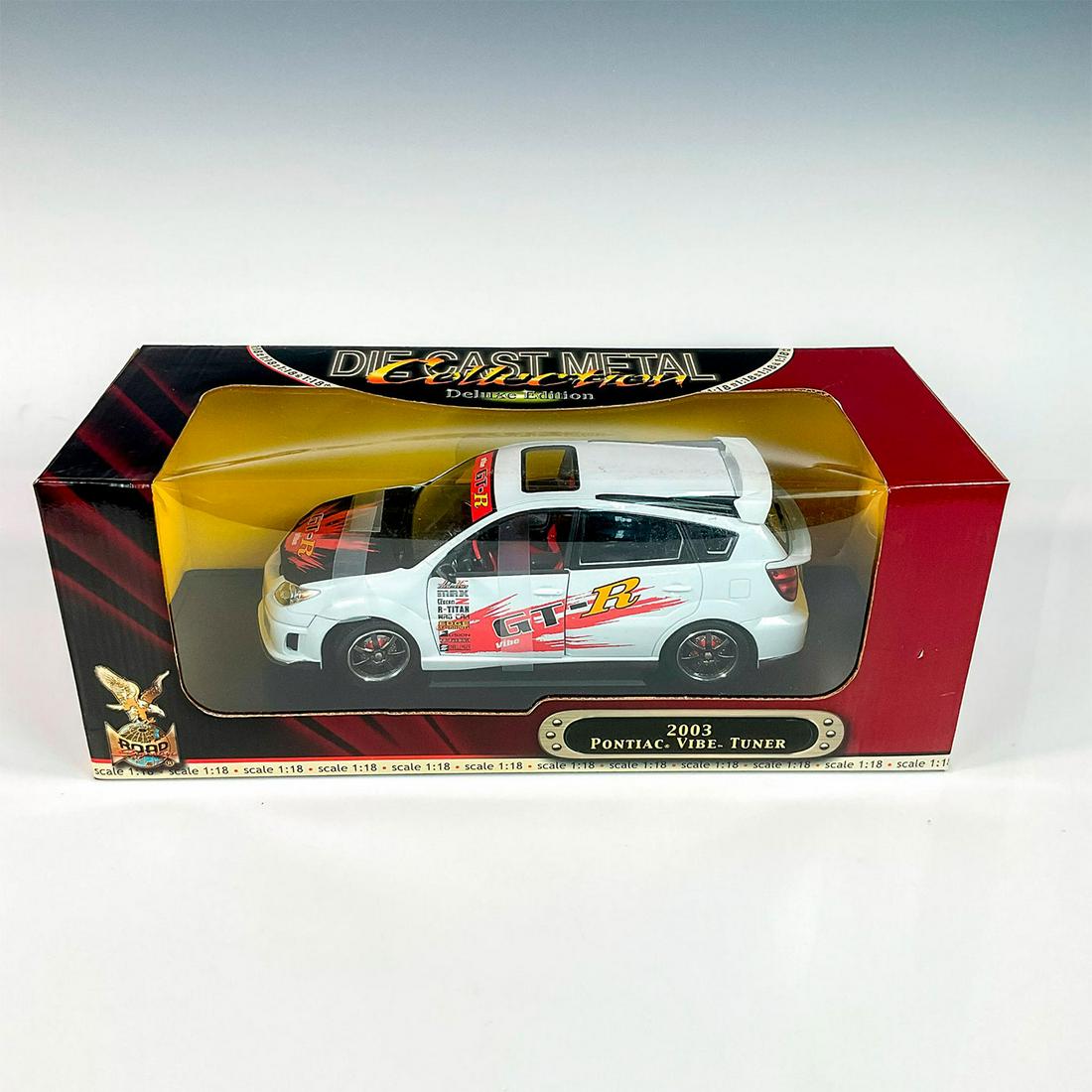 Road Signature Deluxe Edition 2003 Pontiac Vibe Model Car: A factory sealed, replica die cast metal model car Pontiac Vibe Turned designed in a white and black colored exterior and red interior, made with detachable parts. This item has its original box. Box