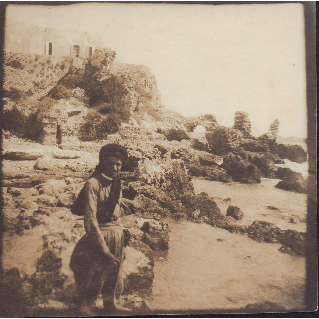 Antique Monochrome Photograph, Ruins of Caesarea: Silver gelatin black and white photograph with square format; sepia toned. Features a middle eastern gentleman in front of archaeological ruins by the sea in Caesarea. Handwritten description in penci