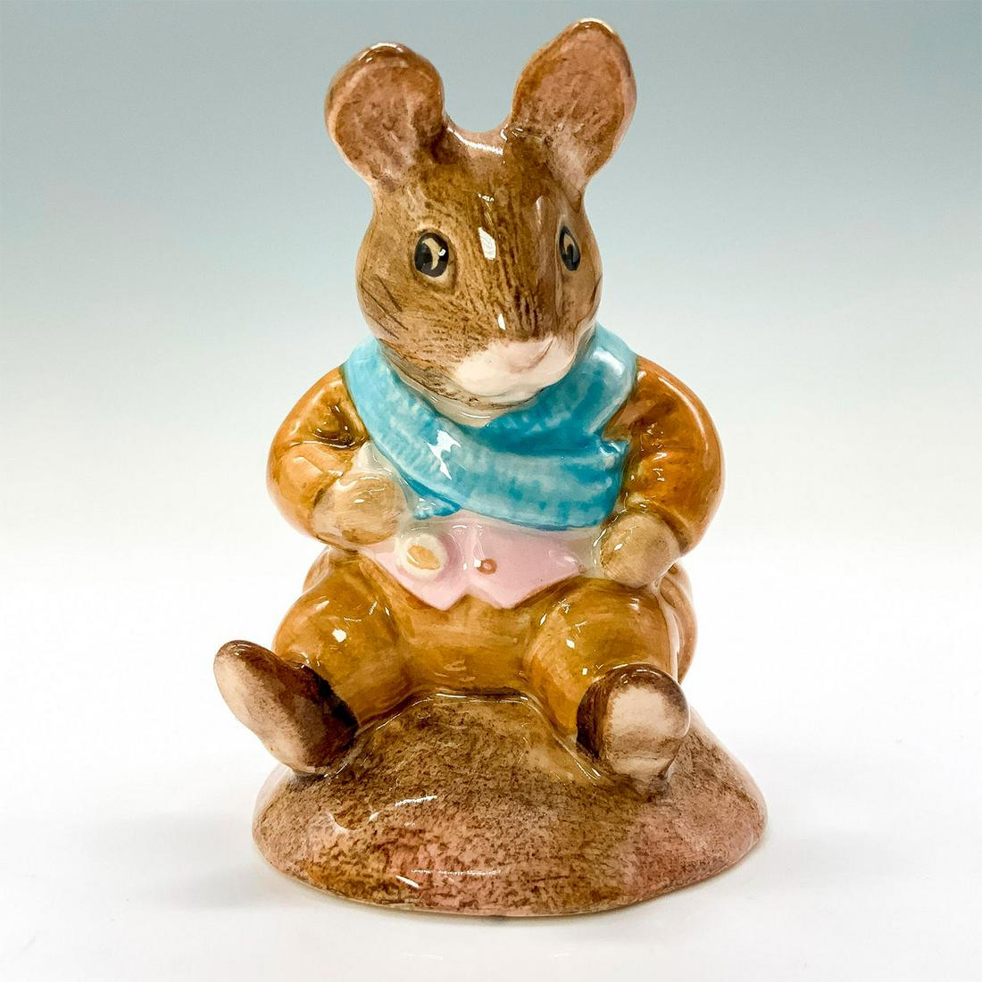 Beswick Beatrix Potter Figurine, Old Mr. Bouncer: A figurine of a bunny sitting down wearing a tan jacket and tan pants along with a blue scarf and pink vest. Beswick backstamp. Dimensions: 2"L x 2.25"W x 3"H Manufacturer: Beswick Country of Origin: