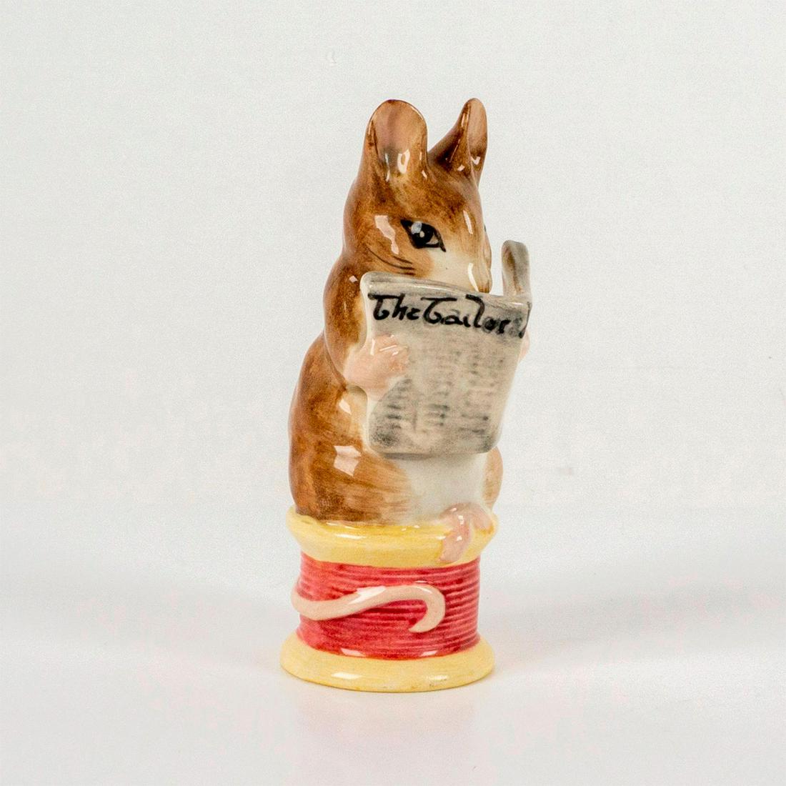 Beswick Beatrix Potter's Figurine, Tailor of Gloucester: Depicts a mouse reading a newspaper while sitting on top of a spool of magenta thread. Beswick backstamp. Dimensions: 1.25"L x 1.25"W x 3.5"H Manufacturer: Beatrix Potter Country of Origin: England
