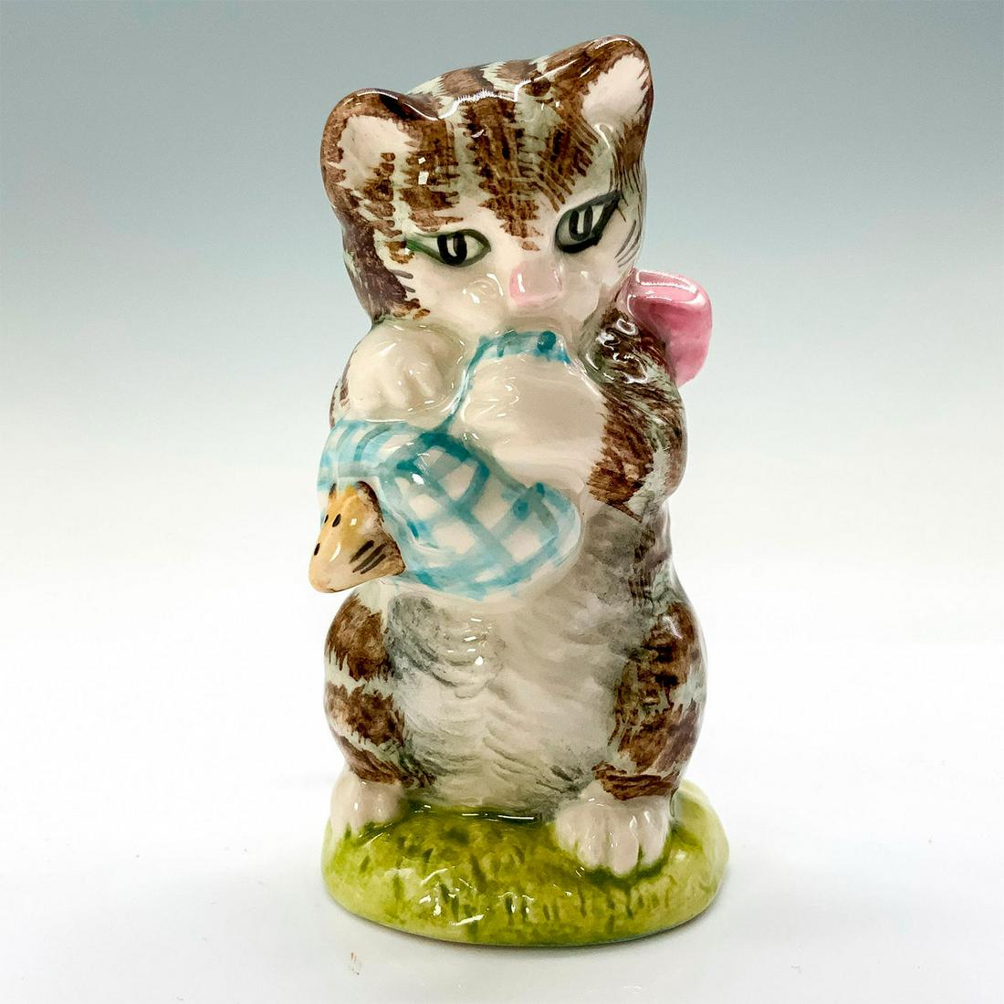 Royal Albert Beatrix Potter Figurine, Miss Moppet: A figurine of Miss Moppet standing on her hind legs wearing a pink bow around her neck while playing with a mouse wrapped in fabric. This item has its original box. Dimensions of the original box: 2.5
