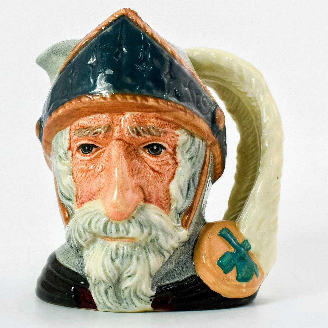 Don Quixote D6460 - Small - Royal Doulton Character Jug: Blue-grey helmet; dark green robes. Don Quixote is the hero of the novel by Cervantes, a satirical parody of this chivalrous knight. Don Quixote leads a life of adventure, capturing many hearts along 