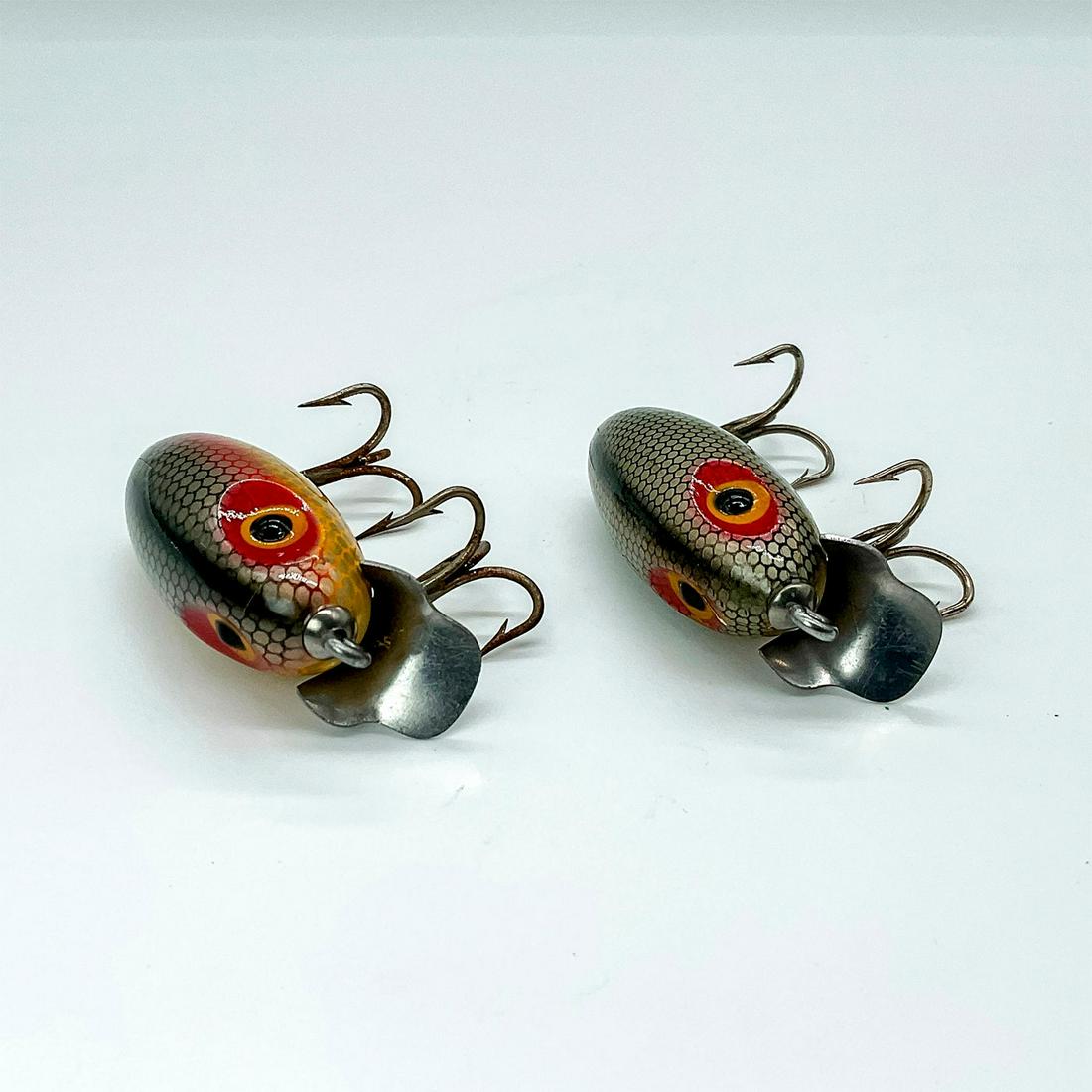 Pair of Vintage Water-Scouts Grey Scale Dent Eye: Two stout little lures of wood, painted in grey and rainbow scale with dent painted eyes. Interesting metal undercarriage hook hardware with dive lip. Dimensions: 2"L Manufacturer: Clark's Country of 