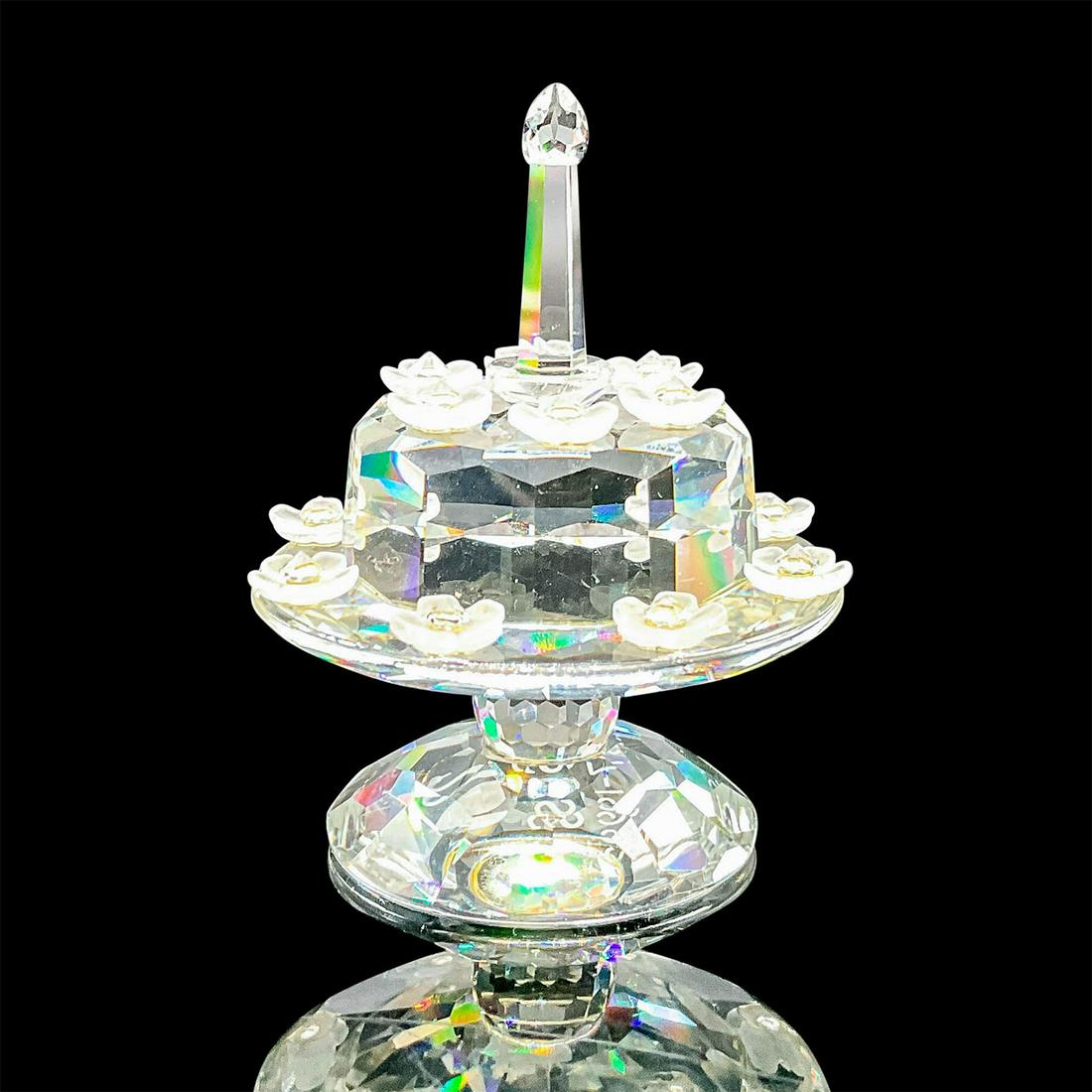 Swarovski Crystal Figurine, Birthday Cake 169678: Limited edition SCS birthday cake made to commemorate the 5th anniversary of the SCS. Clear crystal cake on a stand decorated with frosted crystal flowers. Swarovski etched backstamp. This item has it