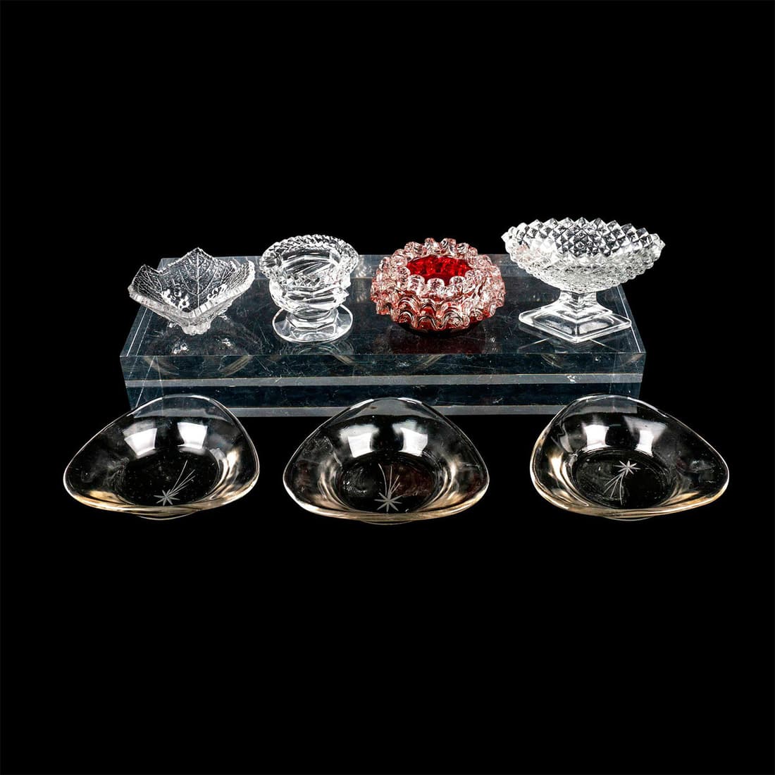 7pc Vintage Glass Salt Cellars: Assorted translucent salt cellars in various moldings and cut designs. Measurements of smallest to largest: 2.5in x 2.5in x 1in to 3.5in x 3.5in x 0.75in. This item has no reserve.