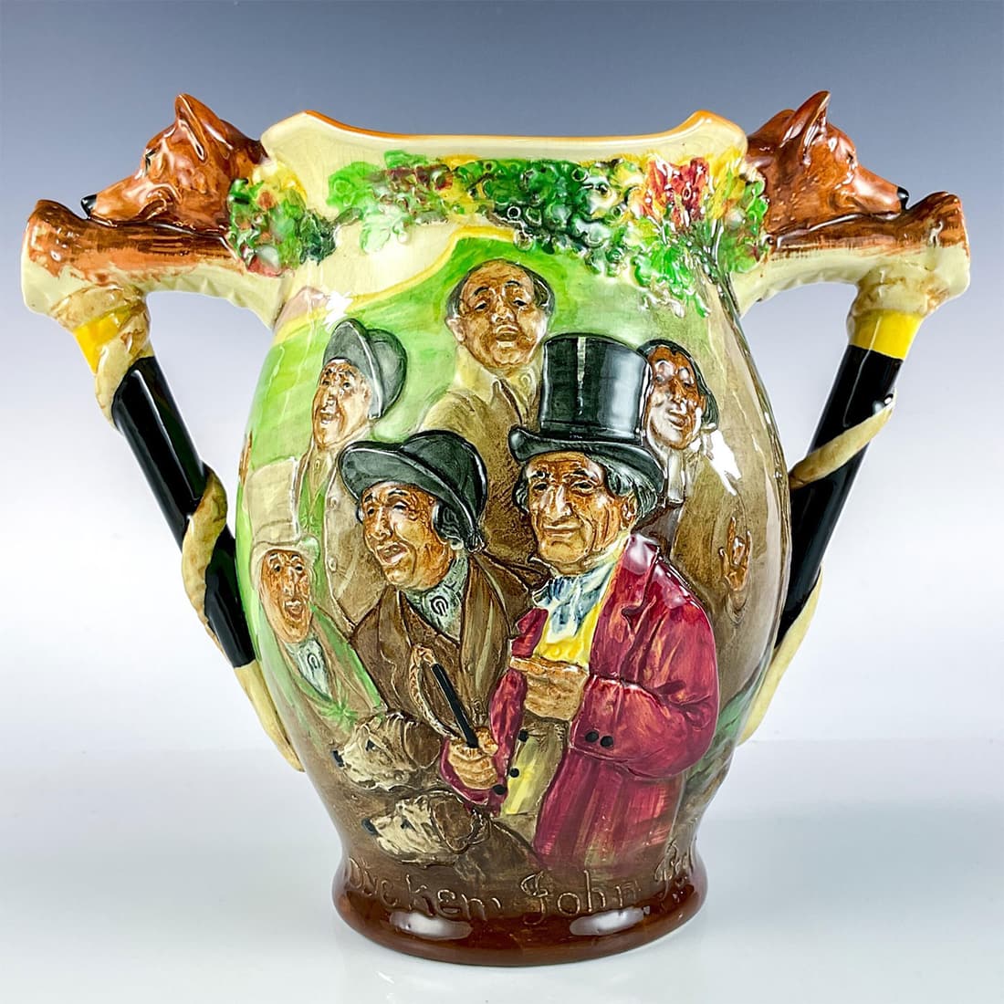 Vintage Royal Doulton Loving Cup, John Peel: Glossy finish. Depicting character with friends on one side and hunting dogs on reverse in relief, with fox and walking stick handles. Royal Doulton backstamp. This item has no reserve. Certificate of