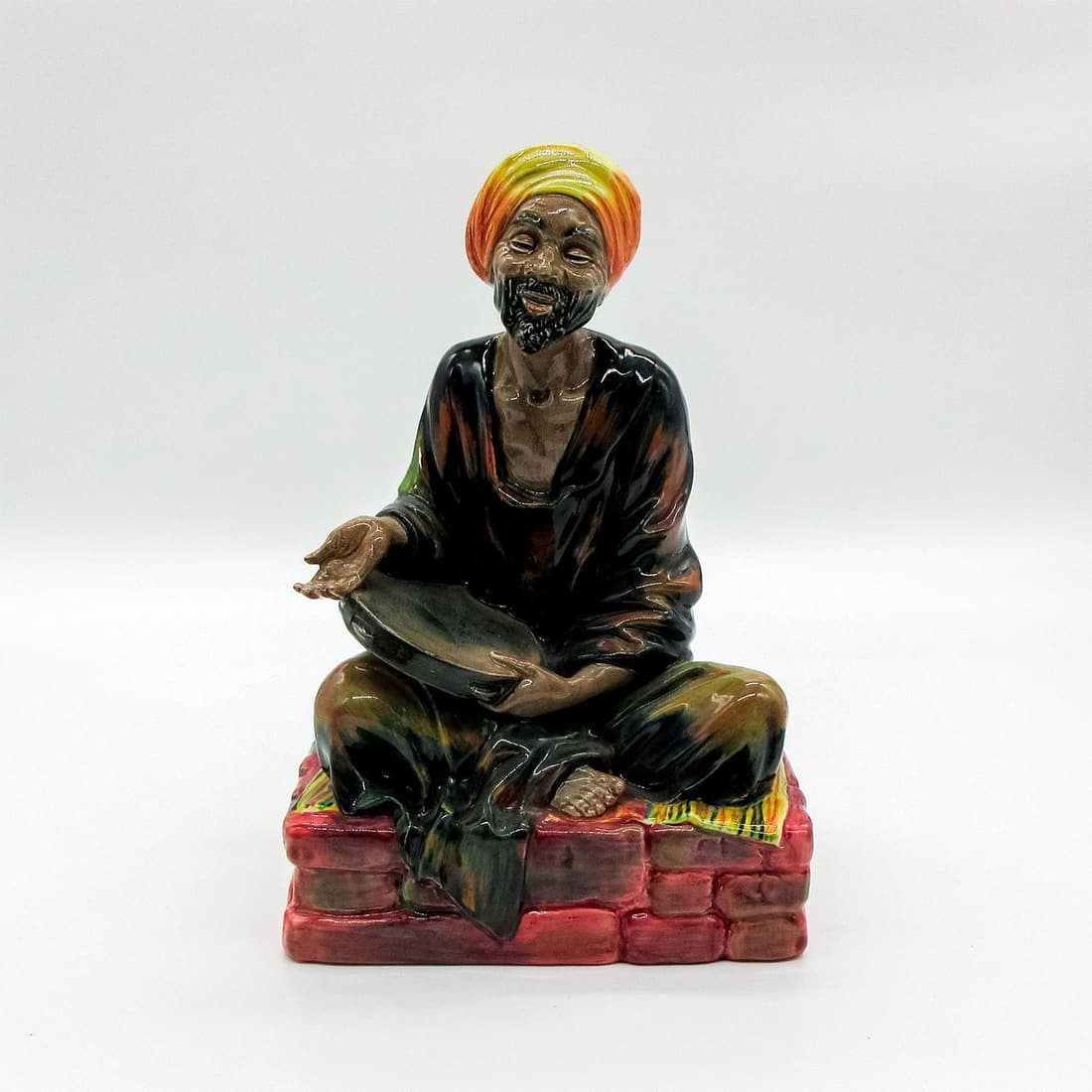 Mendicant - HN1365 - Royal Doulton Figurine: Middle Eastern Heritage series. Royal Doulton backstamp. Artist: Leslie Harradine Issued: 1929 - 1969 Dimensions: 8.25"H Manufacturer: Royal Doulton Country of Origin: England