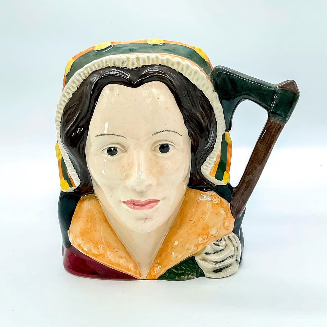 Catherine Howard D6645 - Large - Royal Doulton Character Jug: Style One. Brown, gold, and white coloration. Niece to the Duke of Norfolk, Catherine Howard (1521 - 1542) became Henry VIII's fifth wife on July 28, 1540, in a marriage arranged by her family. In 154