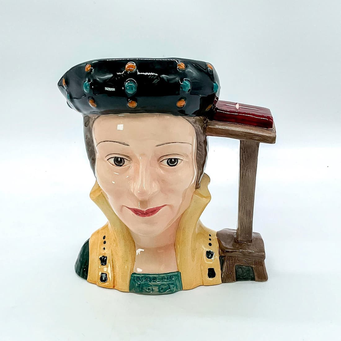 Catherine Parr D6664 - Large - Royal Doulton Character Jug: Style One. Black, brown, and gold coloration. Catherine Parr (1512 - 1548) became Henry VIII's last wife on July 12, 1543, after being twice widowed. She came to wield considerable power in the royal