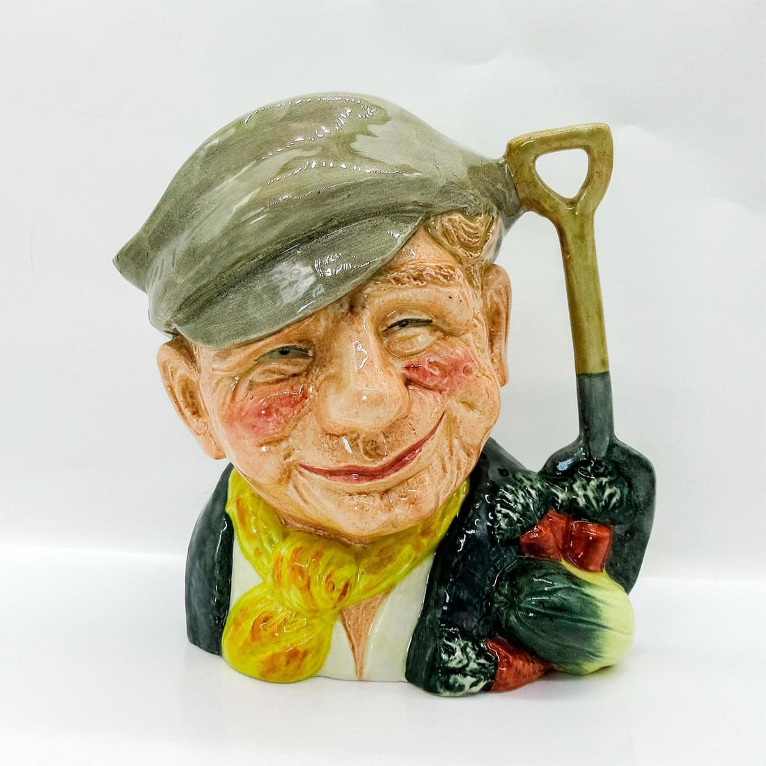 Gardener Old D6630 - Large - Royal Doulton Character Jug: Style One, Variation Two. Yellow scarf, white shirt, light brown hat. Royal Doulton backstamp. Artist: David B. Biggs Issued: 1973 - 1981 Dimensions: 7.75"H Manufacturer: Royal Doulton Country of