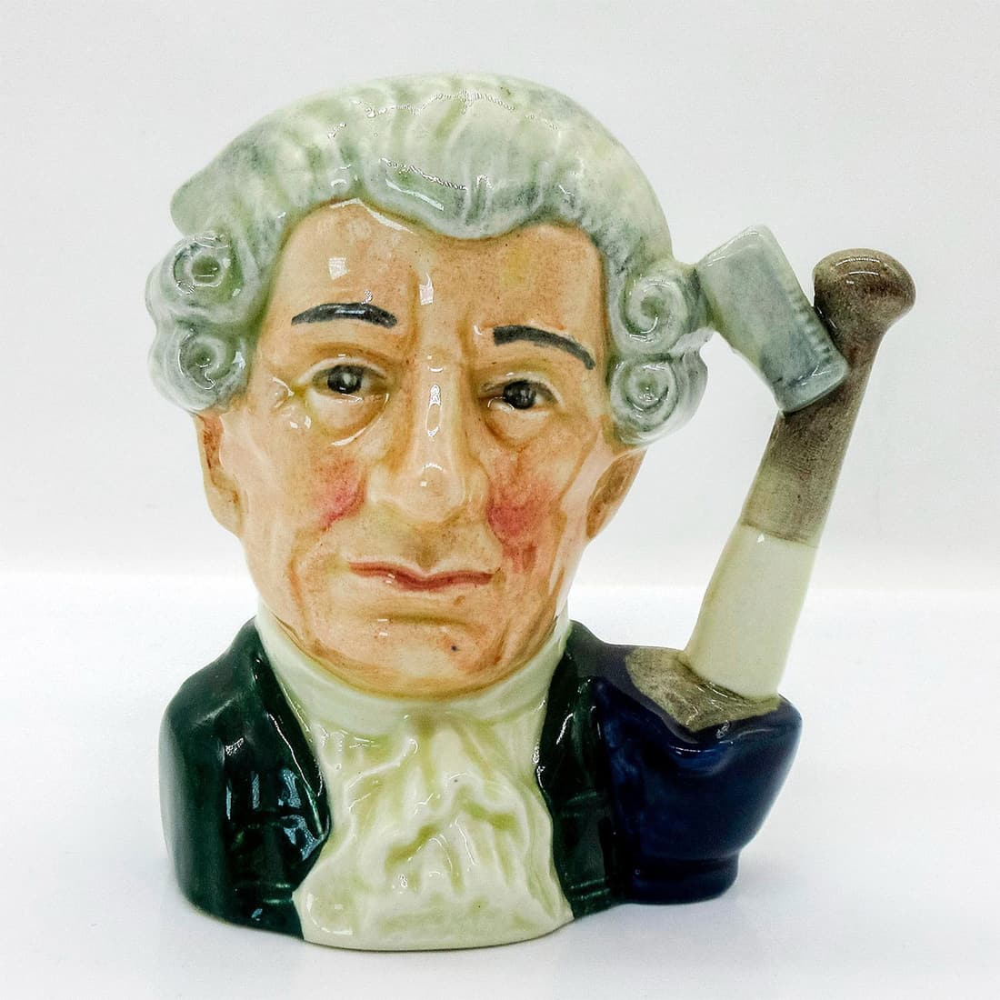 Apothecary D6574 - Small - Royal Doulton Character Jug: Green coat with white cravat; white wig. Along with the other characters in the Williamsburg Series, the apothecary was central to colonial life in 18th century America. Series: Characters From Willia