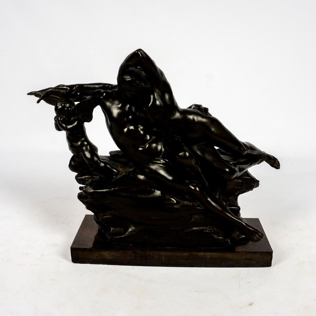 Old Master Style Bronze Figural Sculpture, Cupid and Psyche: Bronze sculpture modeled as a crying Cupid flying away while a nude man restrains Psyche on rocky precipice Modeled in the style of Auguste Rodin. Dark patination. Unsigned. Fixed to rectangular black