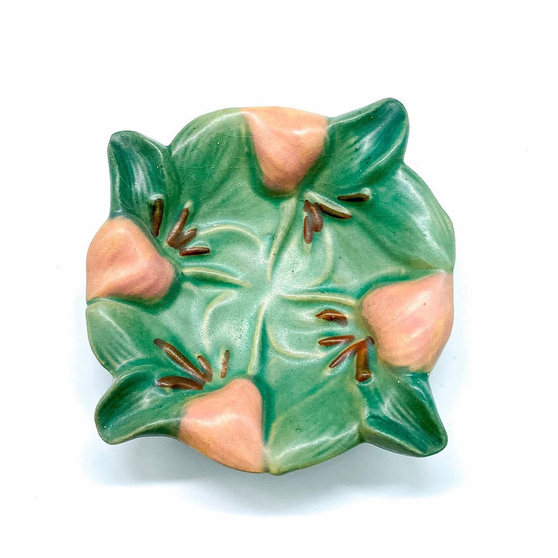 Vintage Roseville Style Green Zephyr Lily Ashtray: Matte ashtray with four cigarette slots. Illegible markings on the bottom. Dimensions: 7"W x 1.25"H Manufacturer: Roseville Pottery Country of Origin: United States