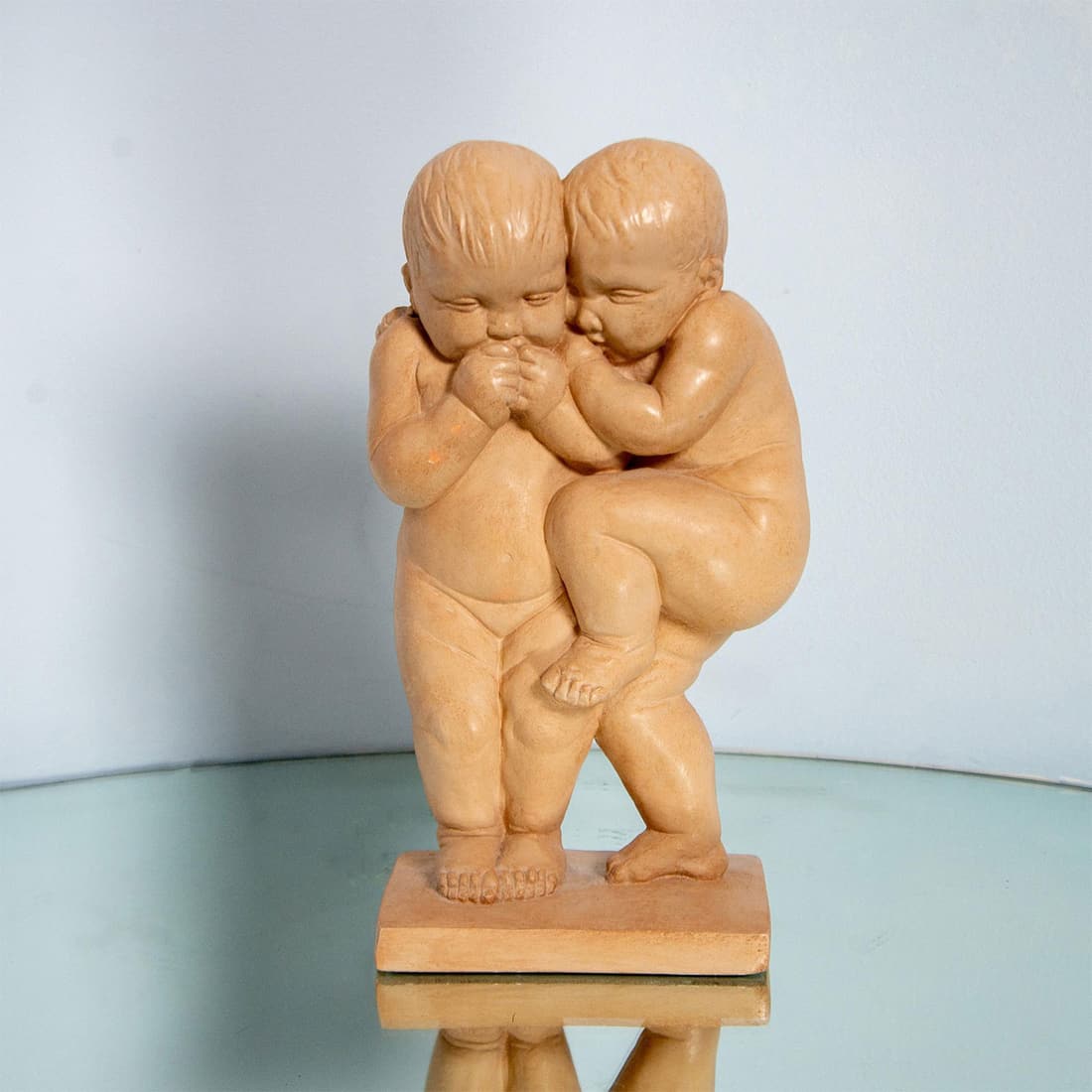 ALVA Museum Replica Sculpture, Little Secrets: Figural sculpture depicting two nude children whispering and giggling fixed to rectangular base. Finished with a light terracotta color. Issued: 1990 Dimensions: 4.25"L x 6.25"W x 13"H Manufacturer: A