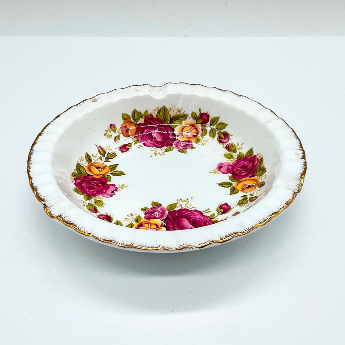 Vintage English Bone China Ashtray, Cottage Rose: A white ashtray with gilded trim decorated with magenta and yellow roses. Dimensions: 5"W x 1"H Country of Origin: England