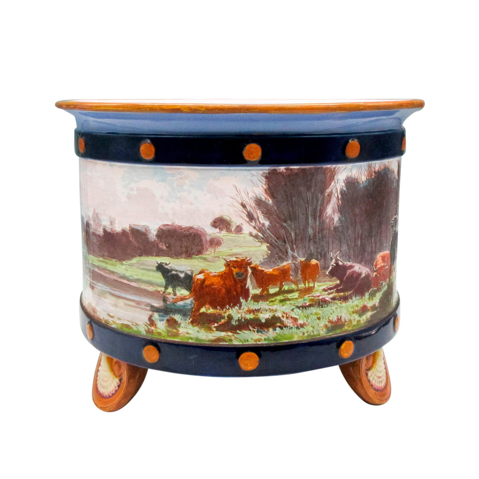Minton Porcelain Jardiniere: Multicolored, flared edge with cattle in pasteur scene on exterior circumference with shell designed feet. Minton backstamp. 1110. Signed. Dimensions: 10"L x 10"W x 8"H Manufacturer: Minton Country of