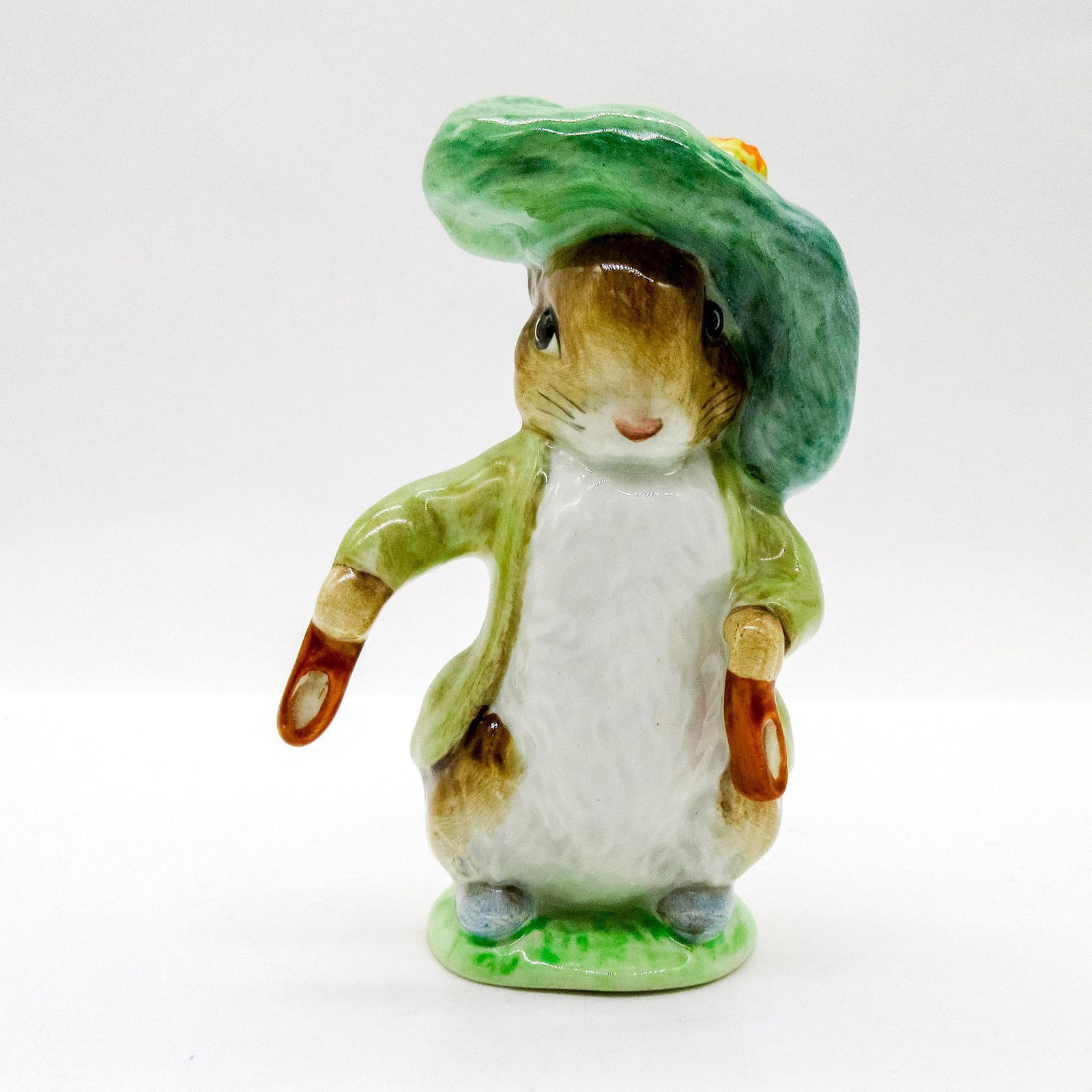 Benjamin Bunny - Beswick - Beatrix Potter Figurine: Porcelain glazed figure of Benjamin Bunny wearing a tan coat and a large green beret holding brown shoes. Beswick England backstamp, gold oval. Issued: 20th c. Dimensions: 4"H Manufacturer: Beswick Co