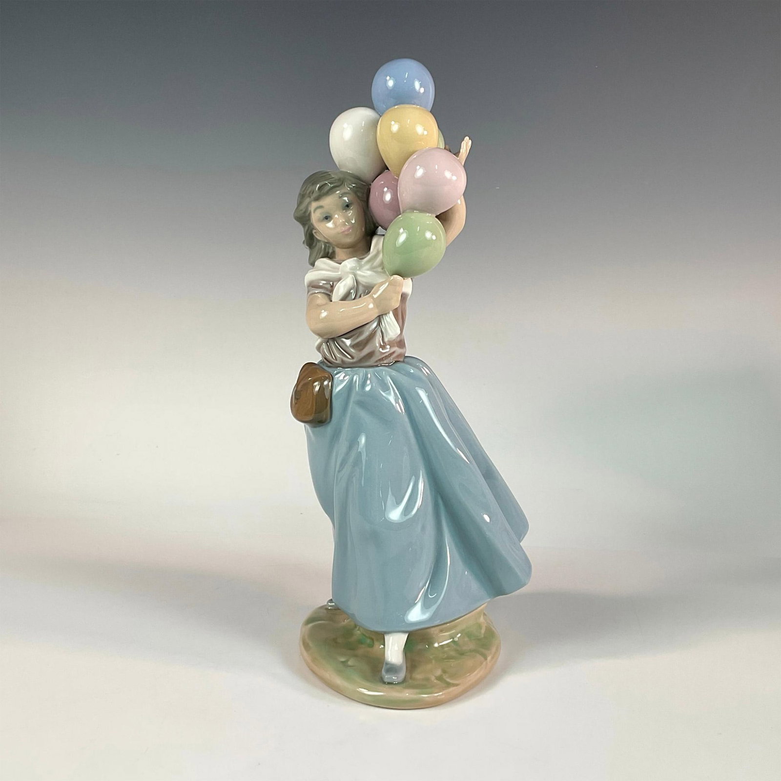 Balloons For Sale 1005141 - Lladro Porcelain Figurine: Glossy finish; Lladro backstamp. Artist: Vicente Martinez Issued: 1982 - 1996 Dimensions: 10.5"H Manufacturer: Lladro Country of Origin: Spain