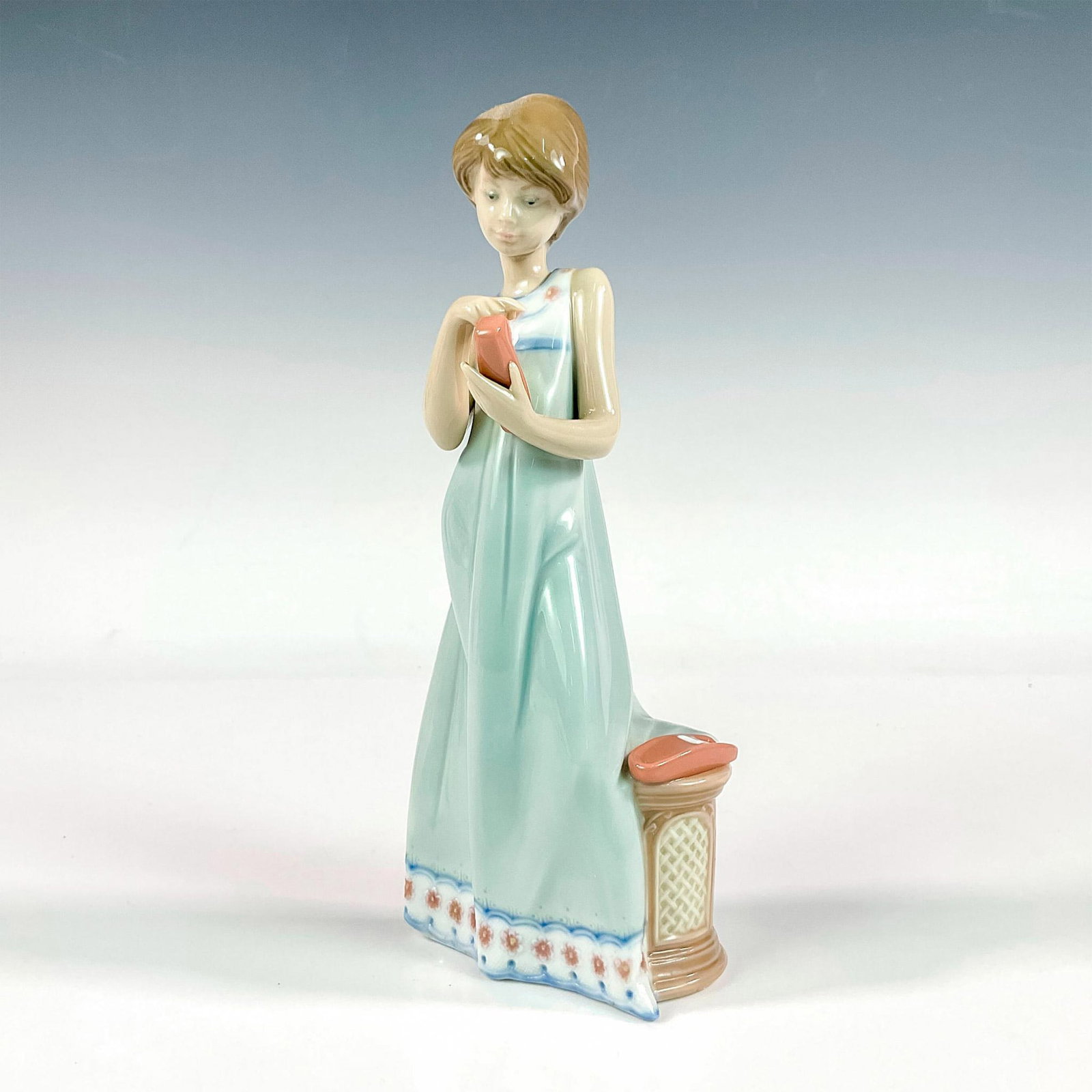 Calling A Friend 1005607 - Lladro Porcelain Figurine: Glossy finish; Lladro backstamp. Includes original box. Box measures: 5.75"L x 11"W x 5"H. Artist: Juan Huerta Issued: 1989 - 1997 Dimensions: 7.75"H x 3.25"W Manufacturer: Lladro Country of Origin:</