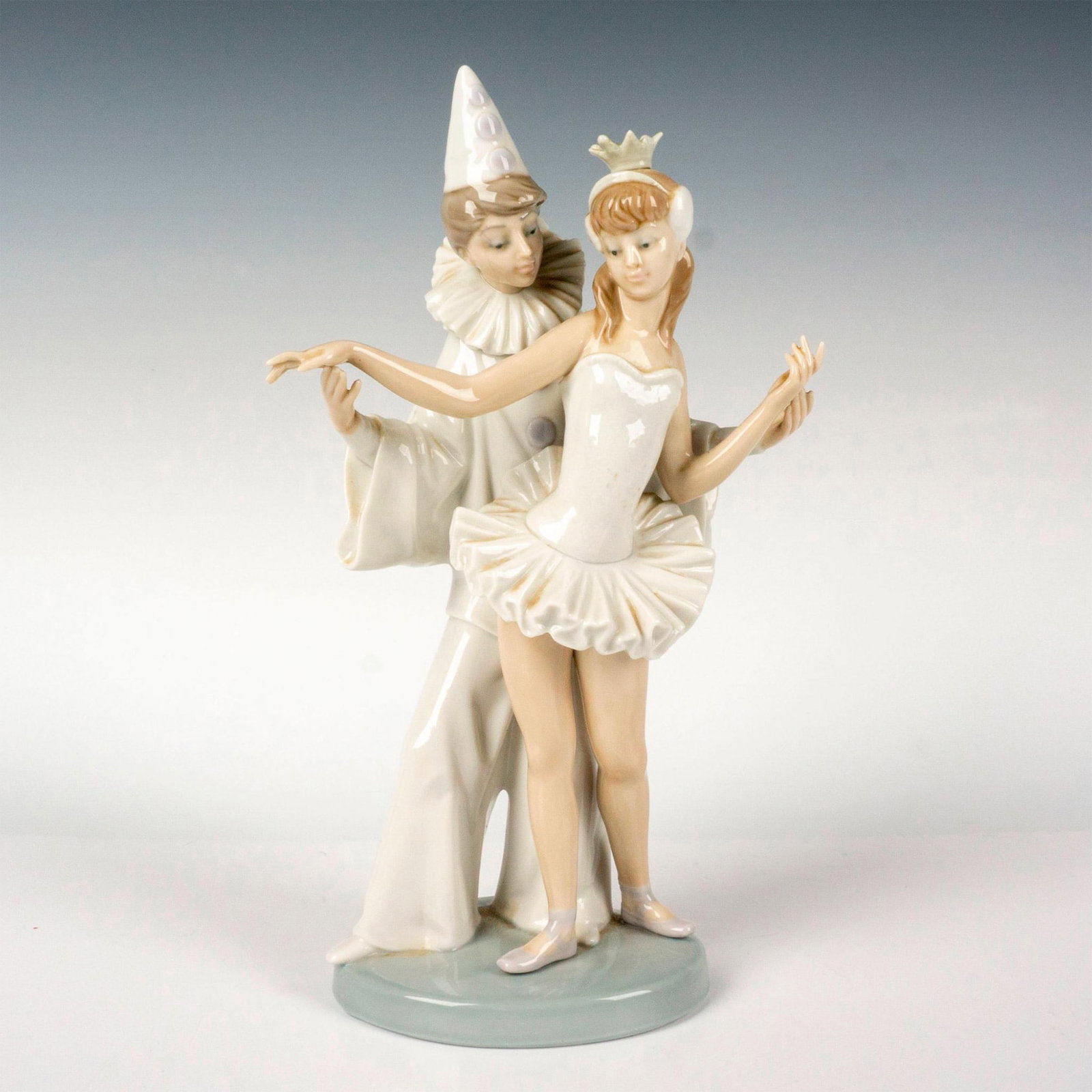 Carnival Couple 1004882 - Lladro Porcelain Figurine: Glossy finish modeled as a ballerina and Pierrot dancing together. Lladro backstamp. Artist: Salvador Furia Issued: 1974-1995 Dimensions: 5"L x 3"W x 10.75"H Manufacturer: Lladro Country of Origin:</