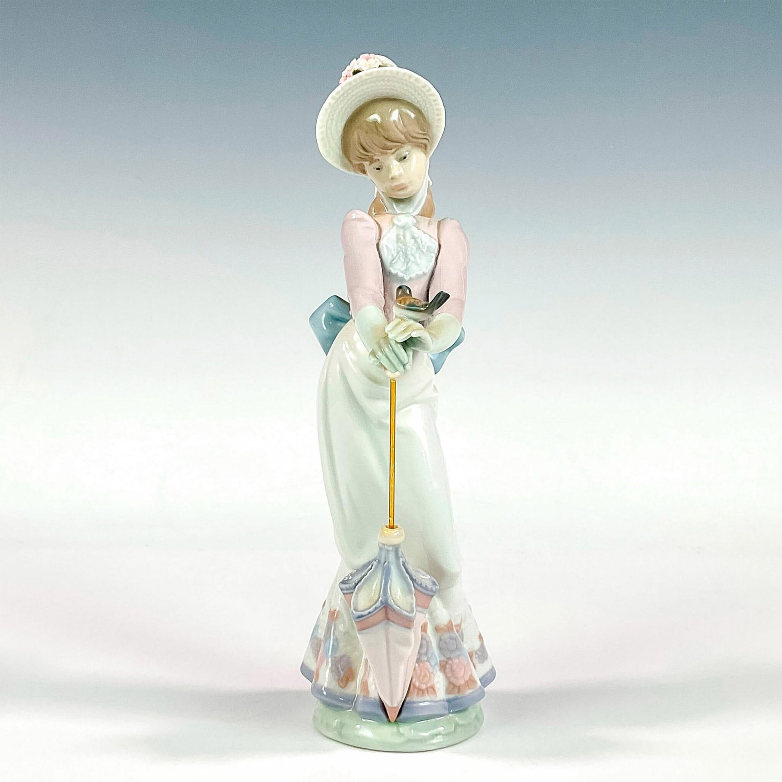 Garden Song 1007618 - Lladro Porcelain Figurine: Glossy finish; Lladro backstamp. Includes original box. Box measures: 5.5"L x 11.25"W x 5"H. Artist: Juan Huerta Issued: 1992 - 1992 Dimensions: 8.75"H Manufacturer: Lladro Country of Origin: Spai