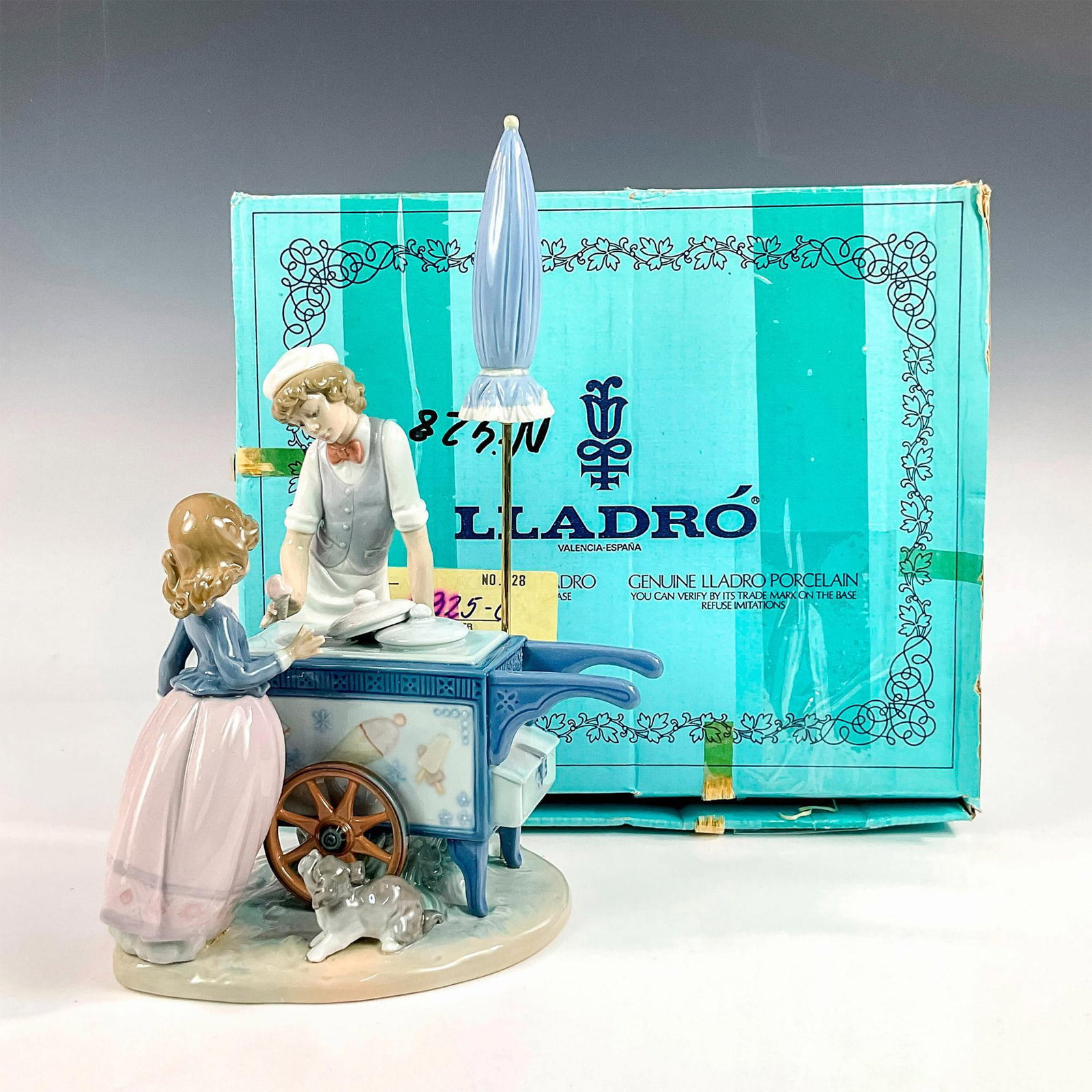 Ice Cream Vendor 1005325 - Lladro Porcelain Figurine: Glossy finish; Lladro backstamp. Includes original box. Box measures: 13.25"L x 11"W x 10.75"H Artist: Antonio Ramos Issued: 1985 - 1995 Dimensions: 11.75"H Manufacturer: Lladro Country of Origin: