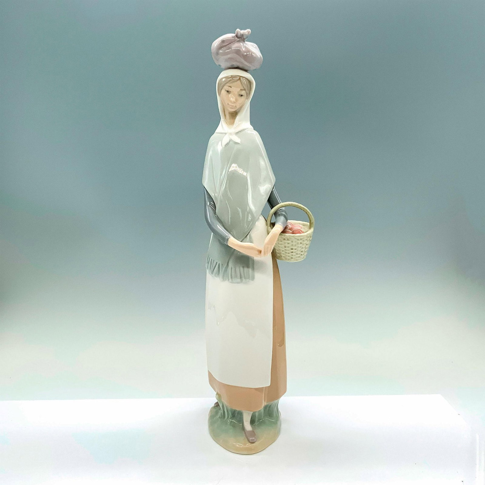 Marketing Day 1004502 - Lladro Porcelain Figurine: Glossy finish; Lladro backstamp. Artist: Fulgencio Garcia Issued: 1969-1985 Dimensions: 4.25"L x 2.75"W x 13.75"H Manufacturer: Lladro Country of Origin: Spain