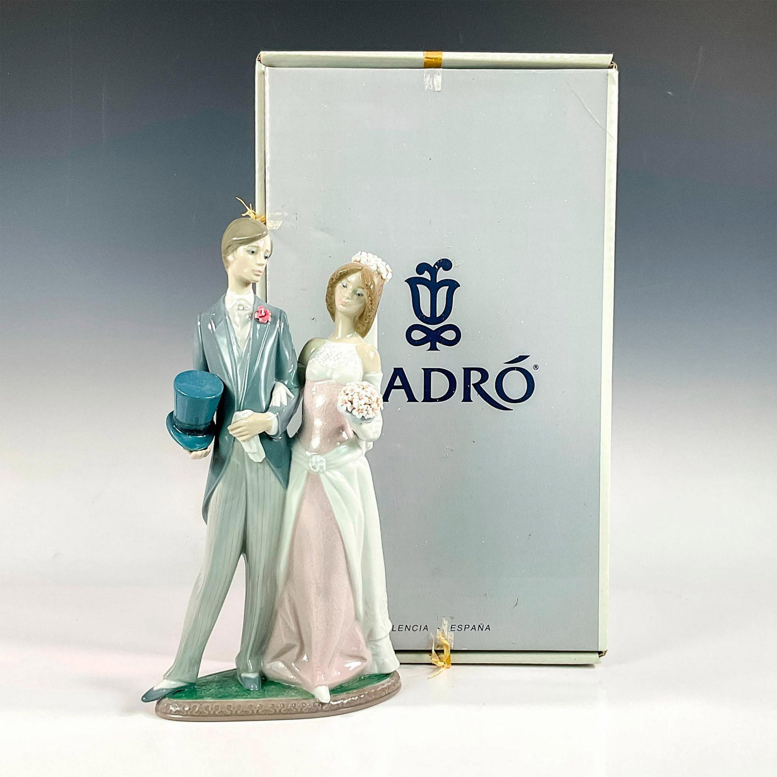 Matrimony 1001404 - Lladro Porcelain Figurine: Glossy finish; Lladro backstamp. Includes original box. Box measures: 9.75" L x 16.75" W x 7.5" H Artist: Juan Huerta Issued: 1982 - 1997 Dimensions: 12.25"H x 6.75"W Edition Number: 408 Edition Size: