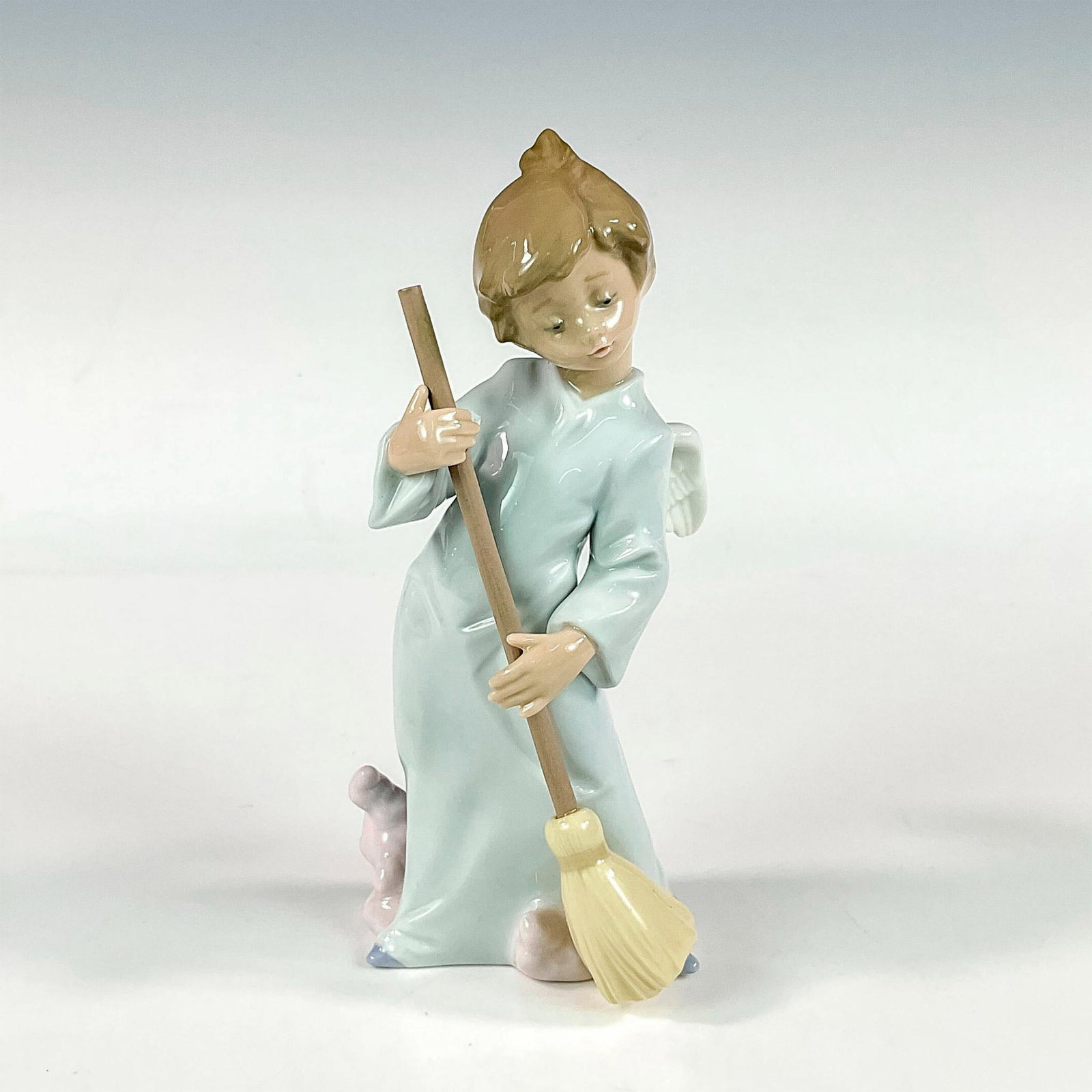 Sweep Away The Clouds 1005726 - Lladro Porcelain Figurine: Glossy finish; Lladro backstamp. Artist: Francisco Polope Issued: 1990 - 2002 Dimensions: 6.5"H Manufacturer: Lladro Country of Origin: Spain
