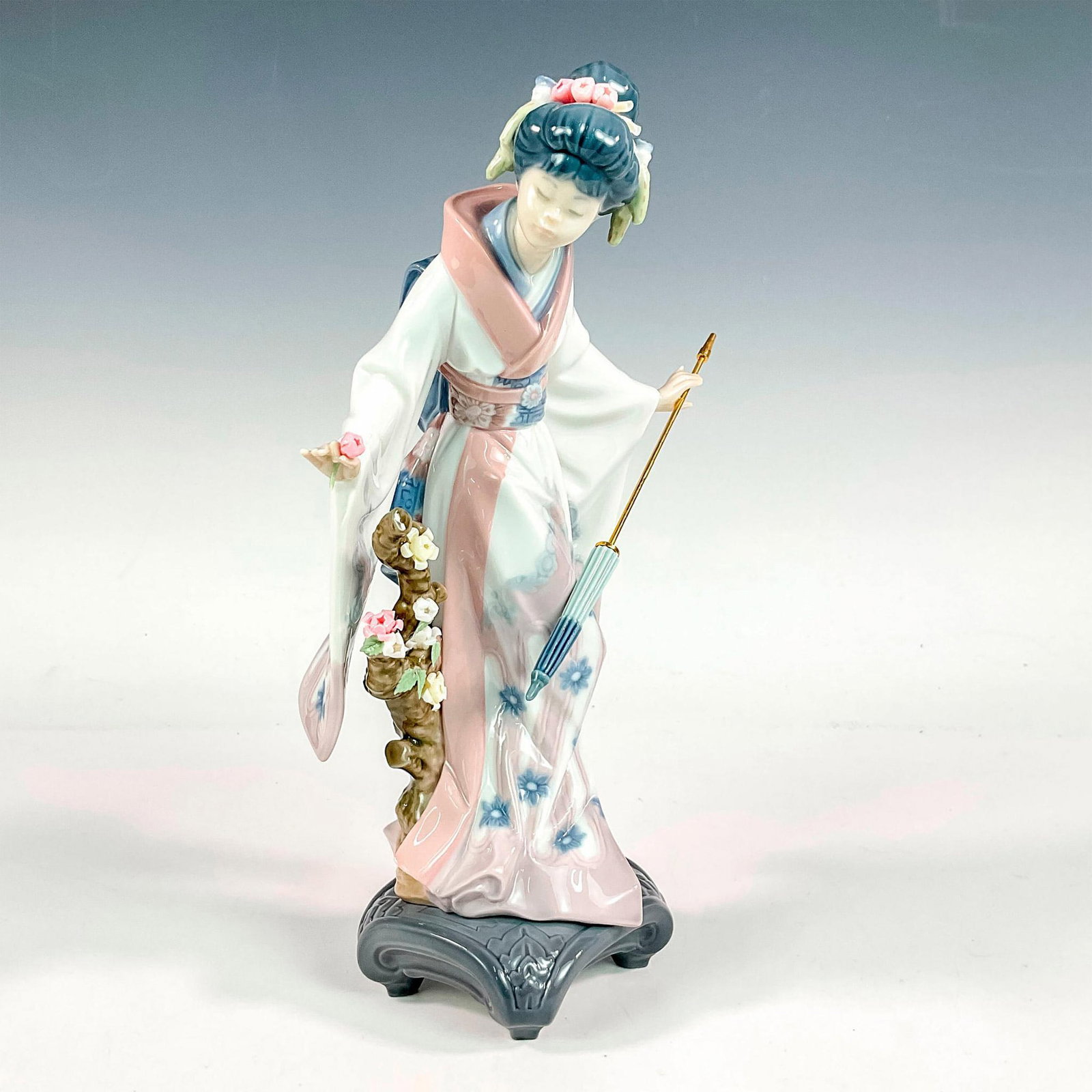 Teruko 1001451 - Lladro Porcelain Figurine: Glossy finish; Lladro backstamp. Artist: Salvador Debon Issued: 1983 - 2013 Dimensions: 10.75"H x 7.5"W Manufacturer: Lladro Country of Origin: Spain
