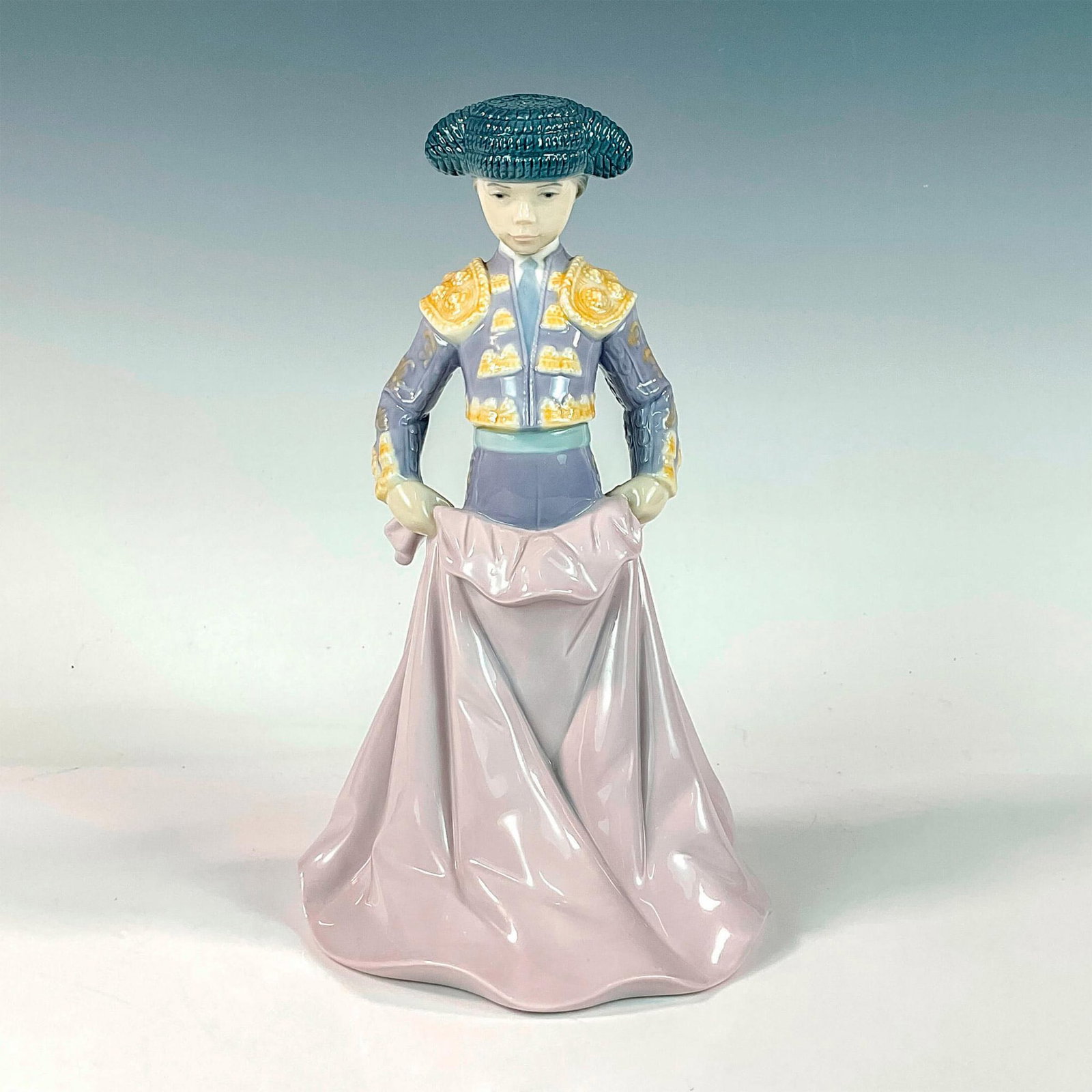 Young Torero 1006438 - Lladro Porcelain Figurine: Glossy finish; Lladro backstamp. Artist: Francisco Catala Issued: 1997 - 2001 Dimensions: 9"H x 5.5"W Manufacturer: Lladro Country of Origin: Spain