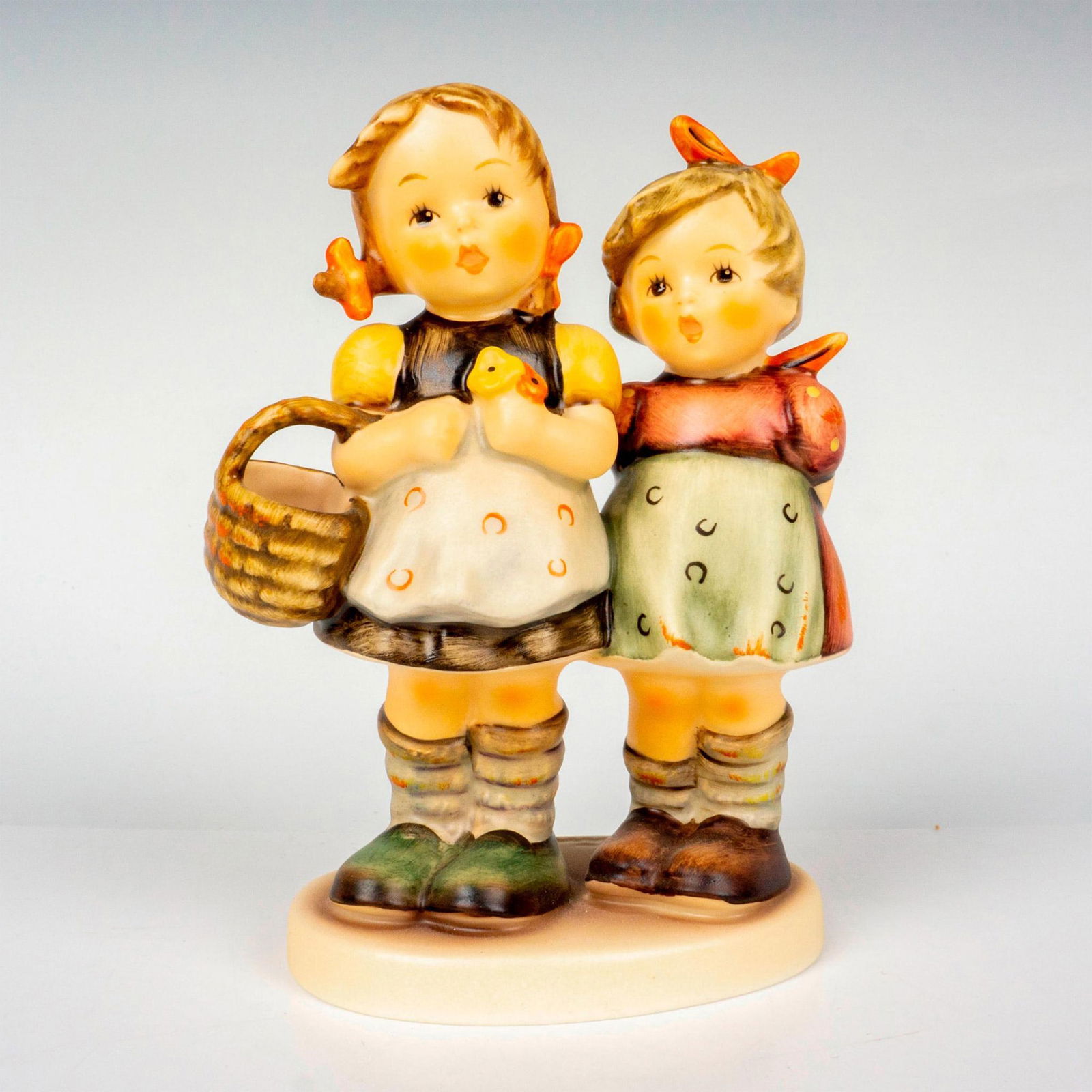 Goebel Hummel Figurine, Daddys Girls: Hand painted in matte finish modeled as two German girls. Hummel M. I. Hummel impressed backstamp. Goebel backstamp. Dimensions: 3"L x 2"W x 5"H Manufacturer: Goebel Hummel Country of Origin: Germany