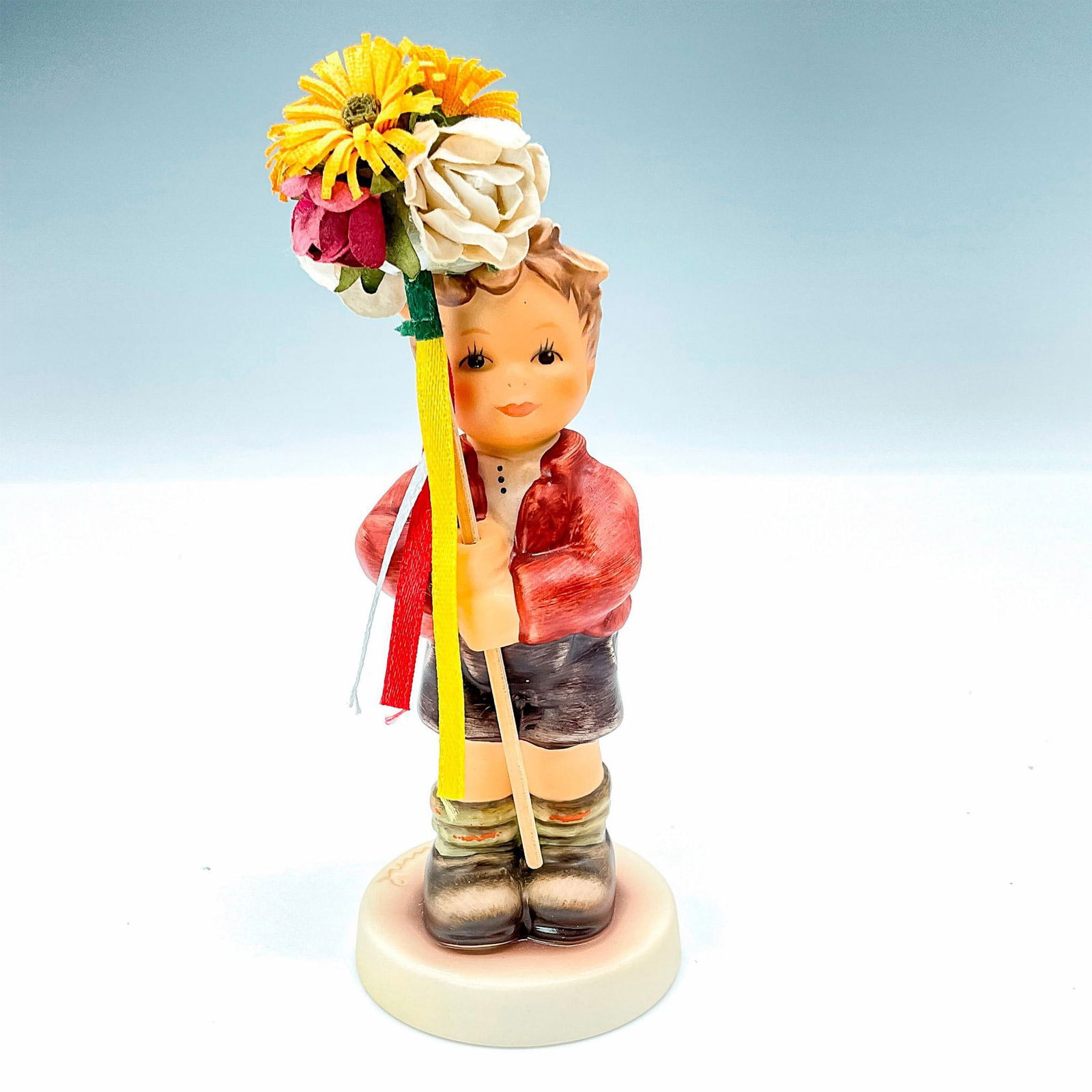 Goebel Hummel Figurine MI Hummel Club Members: This Spring Gifts figurine features a boy holding a group of flowers up on a stick. Figurine #2273 TMK8. Goebel backstamp. Issued: 2008/2009 Dimensions: 2.5"L x 2"W x 5"H Manufacturer: Goebel Hummel C