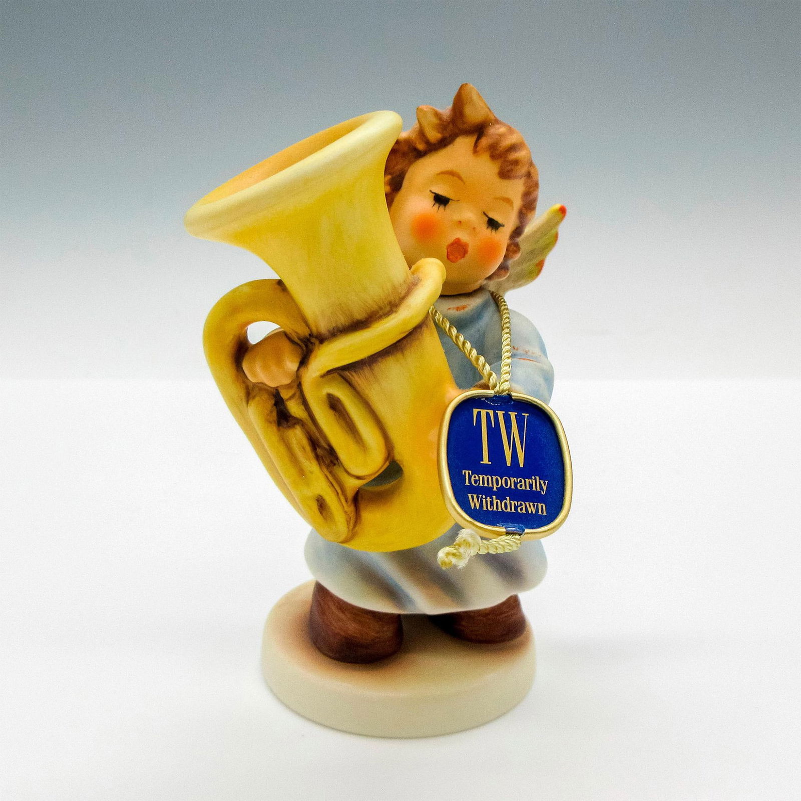 Goebel Hummel Figurine, Heavenly Hubbub 2096/P: Adorable child figural holding tuba. Hummel Goebel tag - Temporarily Withdrawn. Goebel backstamp. Issued: 2000 - 2008 Dimensions: 2"L x 3"W x 4.25"H Manufacturer: Goebel Hummel Country of Origin: Germ