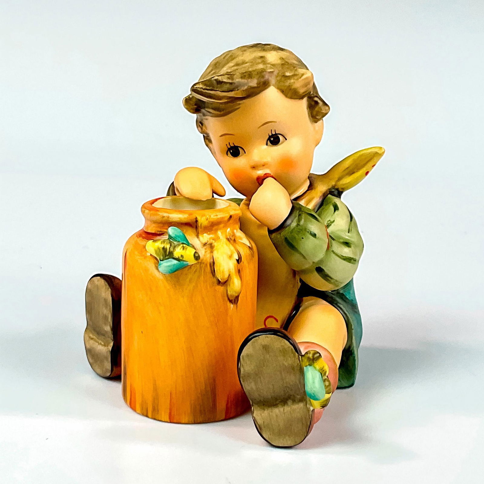 Goebel Hummel Figurine, Honey Lover HUM 312/I: Exclusive edition hand painted figure celebrating the 15th year anniversary of the 1955 molded designed by master sculptor Helmut Wehlte. Goebel Hummel backstamp. Issued: c. 1990-1999 Dimensions: 3.25