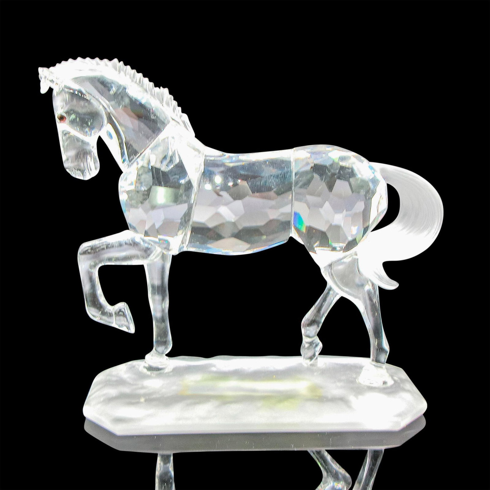 Swarovski Crystal Figurine, Arabian Stallion: Clear faceted body, frosted mane and tail with black crystal eyes. Figural standing on frosted base. Swarovski backstamp. 221609. Issued: 20th century Dimensions: 4.25"L x 1.5"W x 3.5"H Manufacturer: 