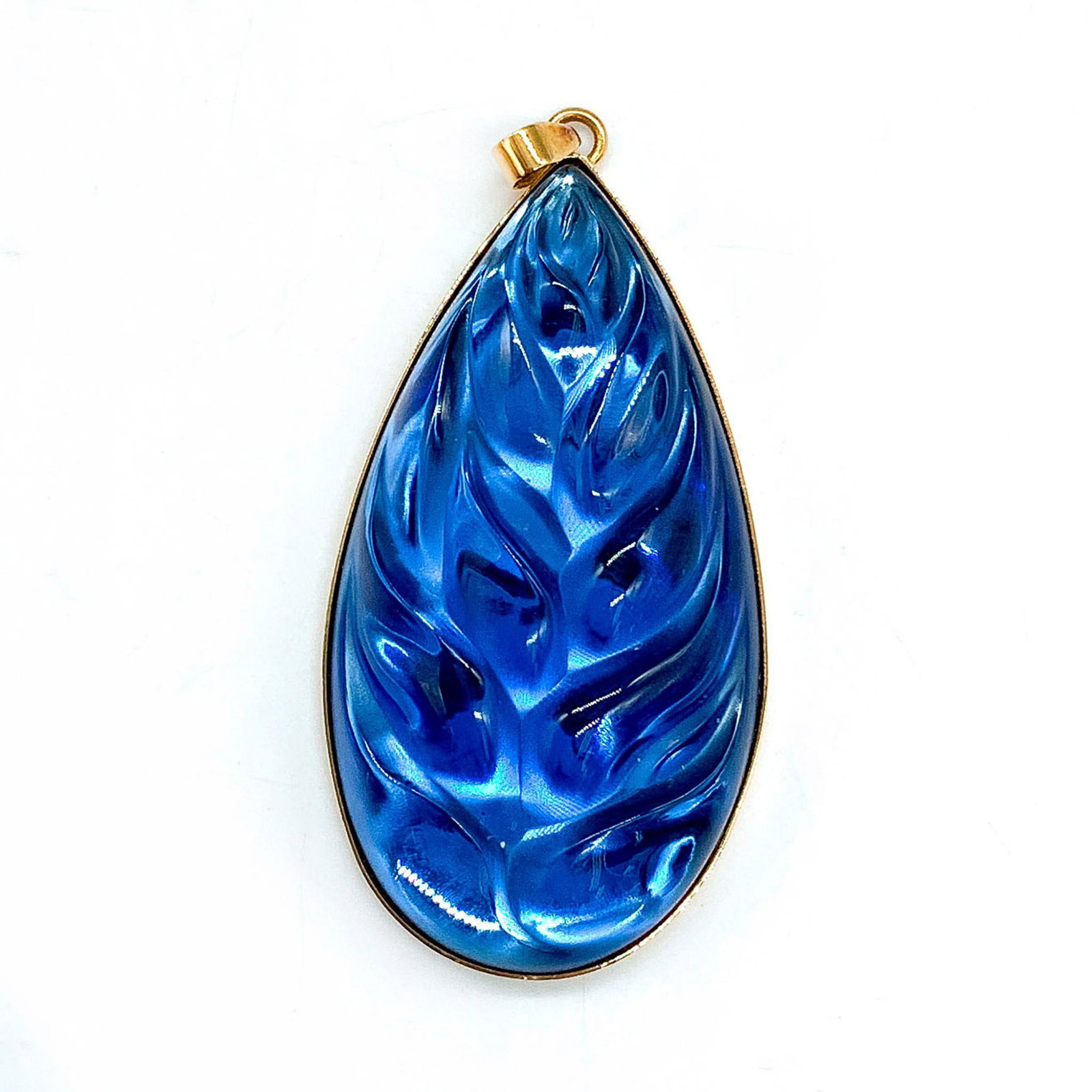 Lalique Crystal Heliconia Blue Leaf Pendant: Inspired by the tropical Heliconia plants of the Caribbean. Marked Lalique France on gold plated back. Dimensions: 2.5"L x 1.25"W Manufacturer: Lalique Country of Origin: France Provenance: Collection