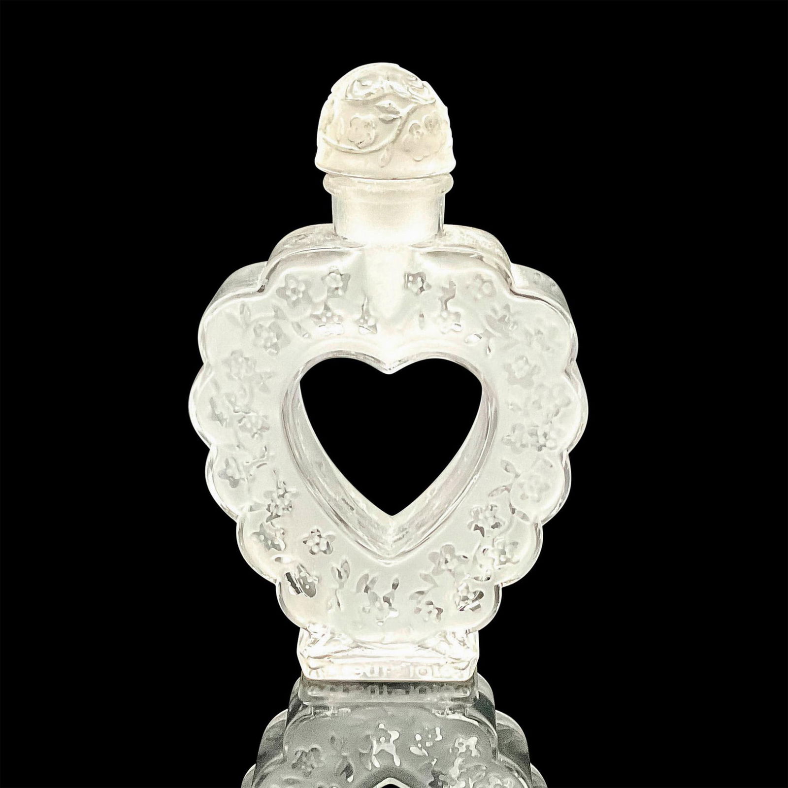 Lalique for Coeur Joie by Nina Ricci Crystal Perfume Bottle: A vintage clear and frosted heart shaped perfume bottle adored with flowers, and a butterfly on the stopper. Coeur Joie Nina Ricci marked on edge. Bottle Made by Lalique France etched on the base. Art